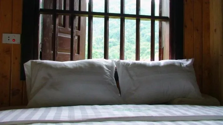 Bed in Whisper Nature Bungalow & Resort