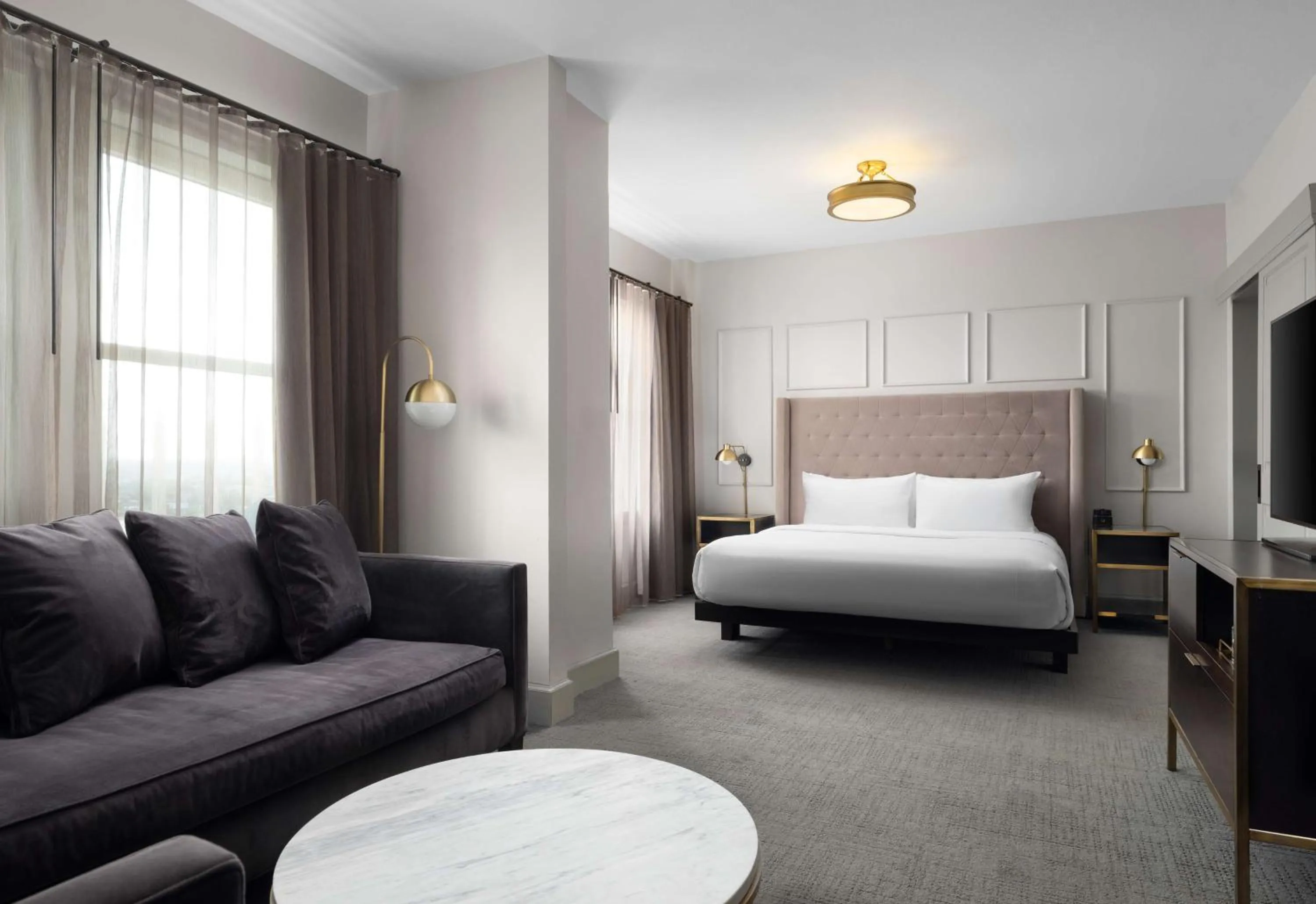 Living room, Bed in Hotel Phillips Kansas City, Curio Collection By Hilton