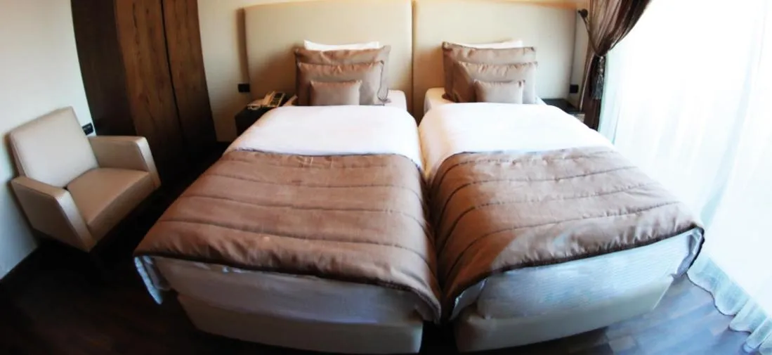 Bed in Royal Garden Hotel