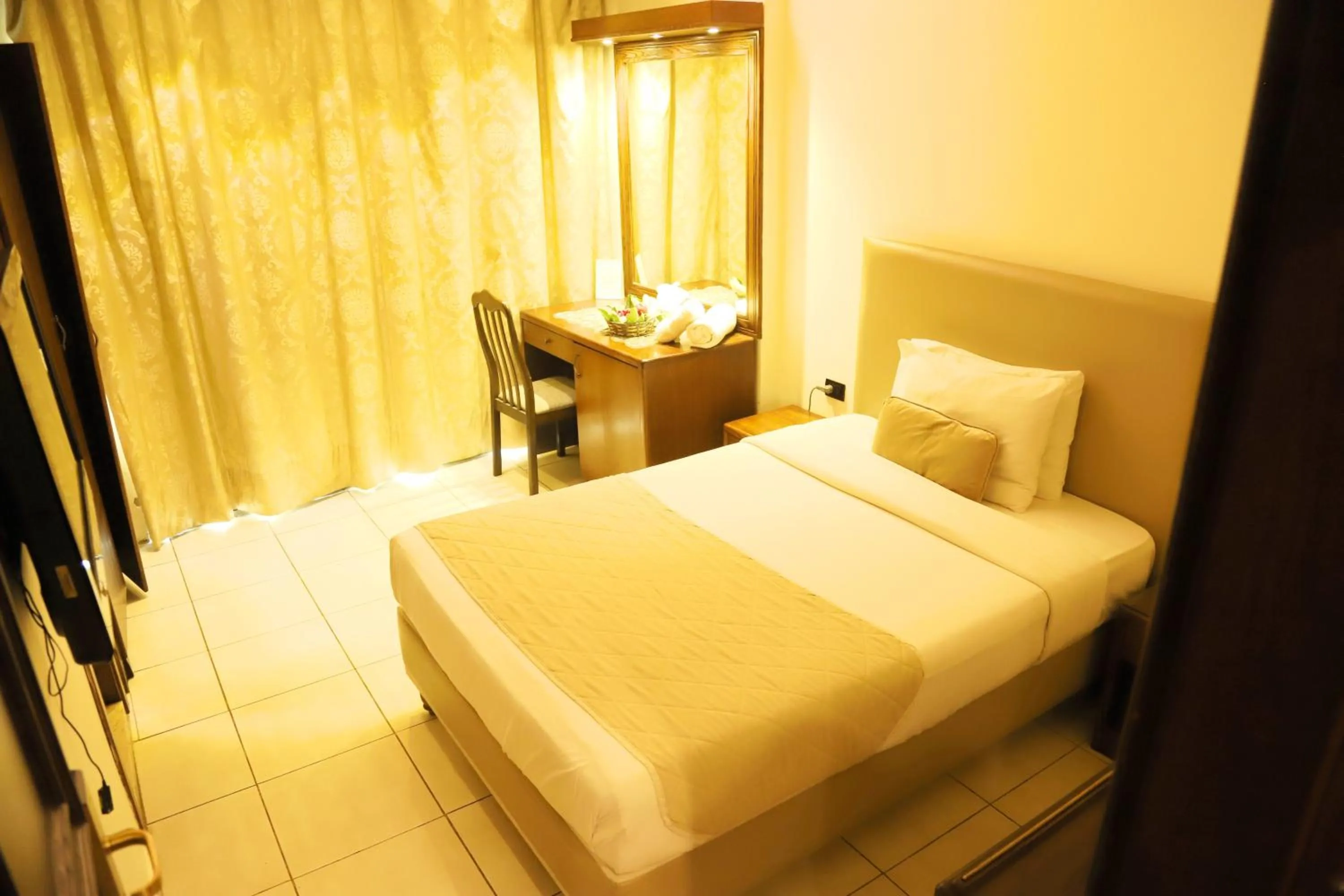 Bed in Royal Garden Hotel