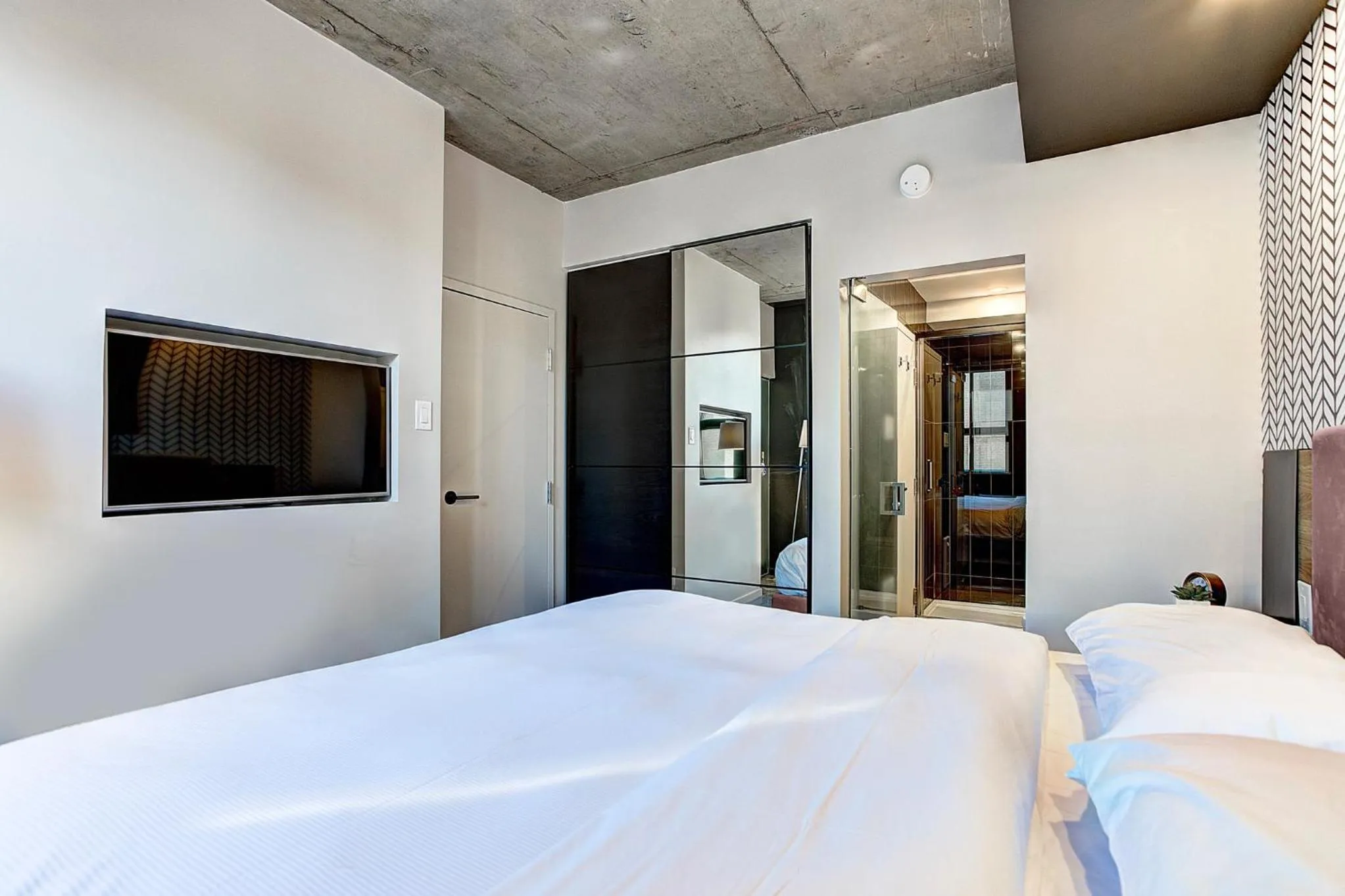 Bed in Pierce Boutique Apartments by Simplissimmo