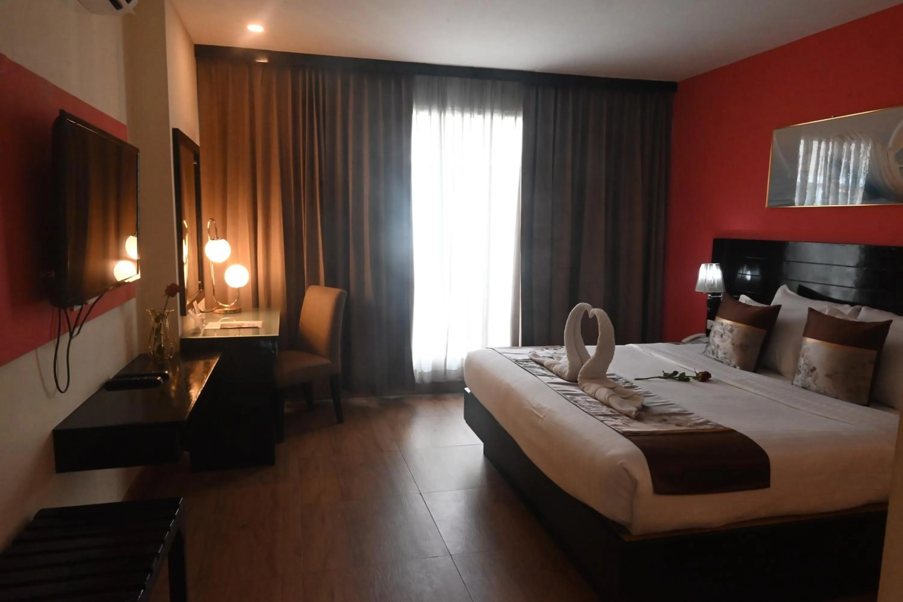 Bed in Boss Suites Nana Hotel