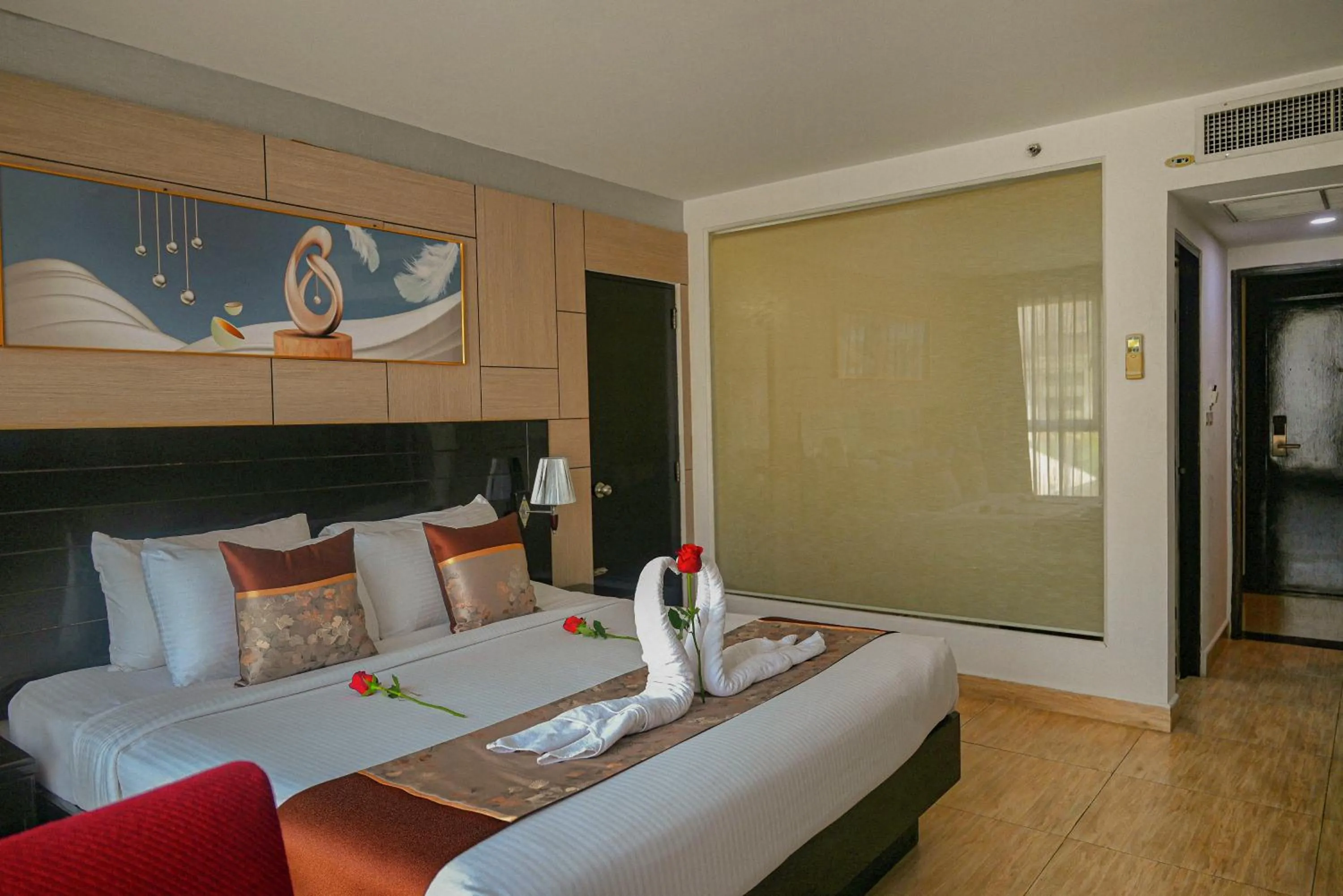 Bed in Boss Suites Nana Hotel