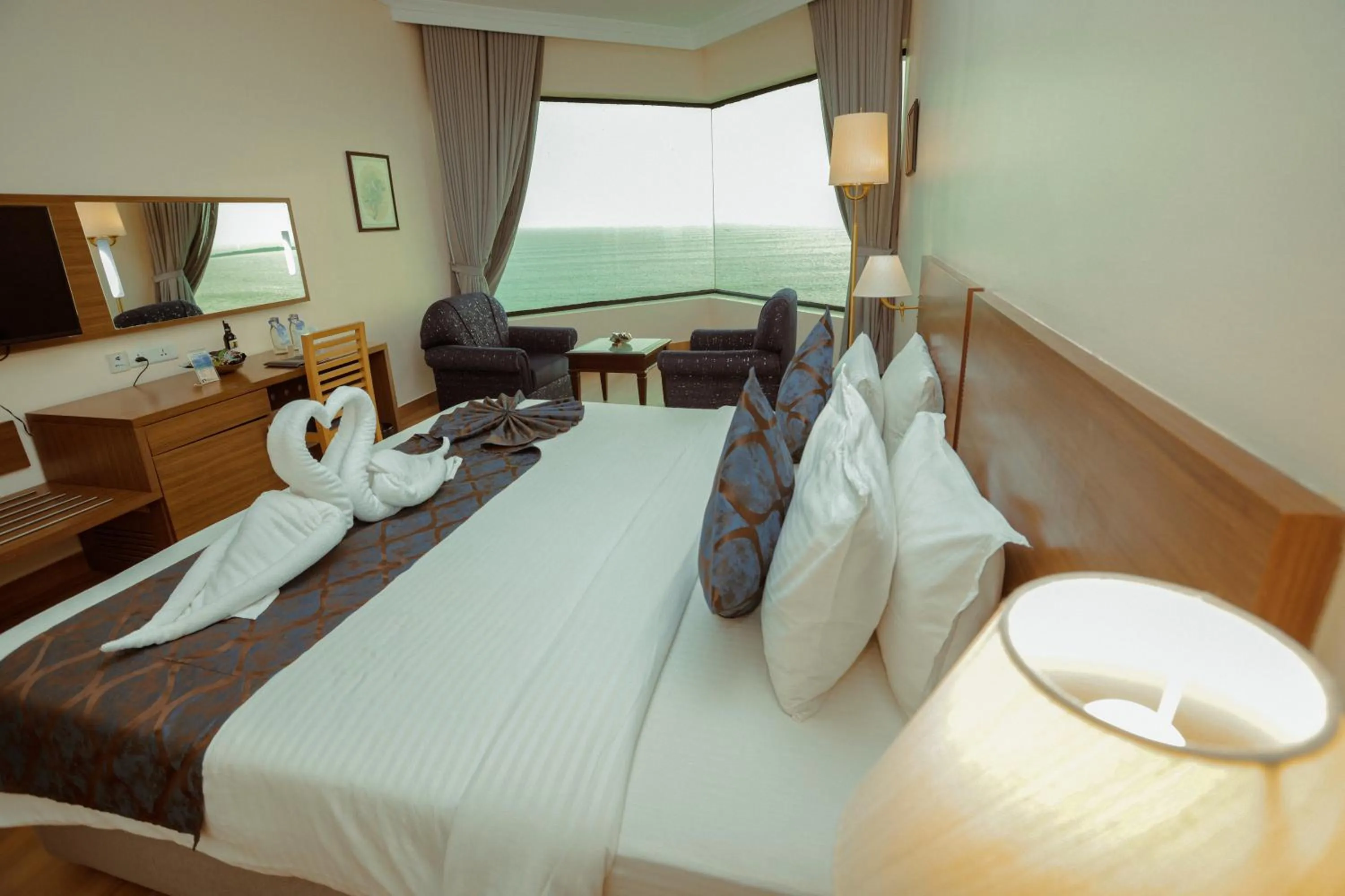 Living room, Bed in The Quilon Beach Hotel and Convention Center