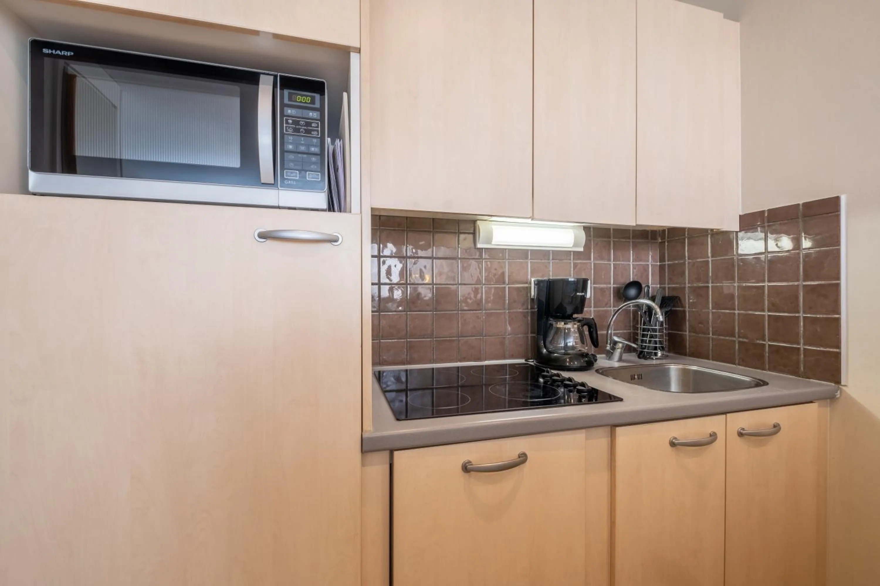 Kitchen or kitchenette in Résidence Pierre & Vacances La Forêt