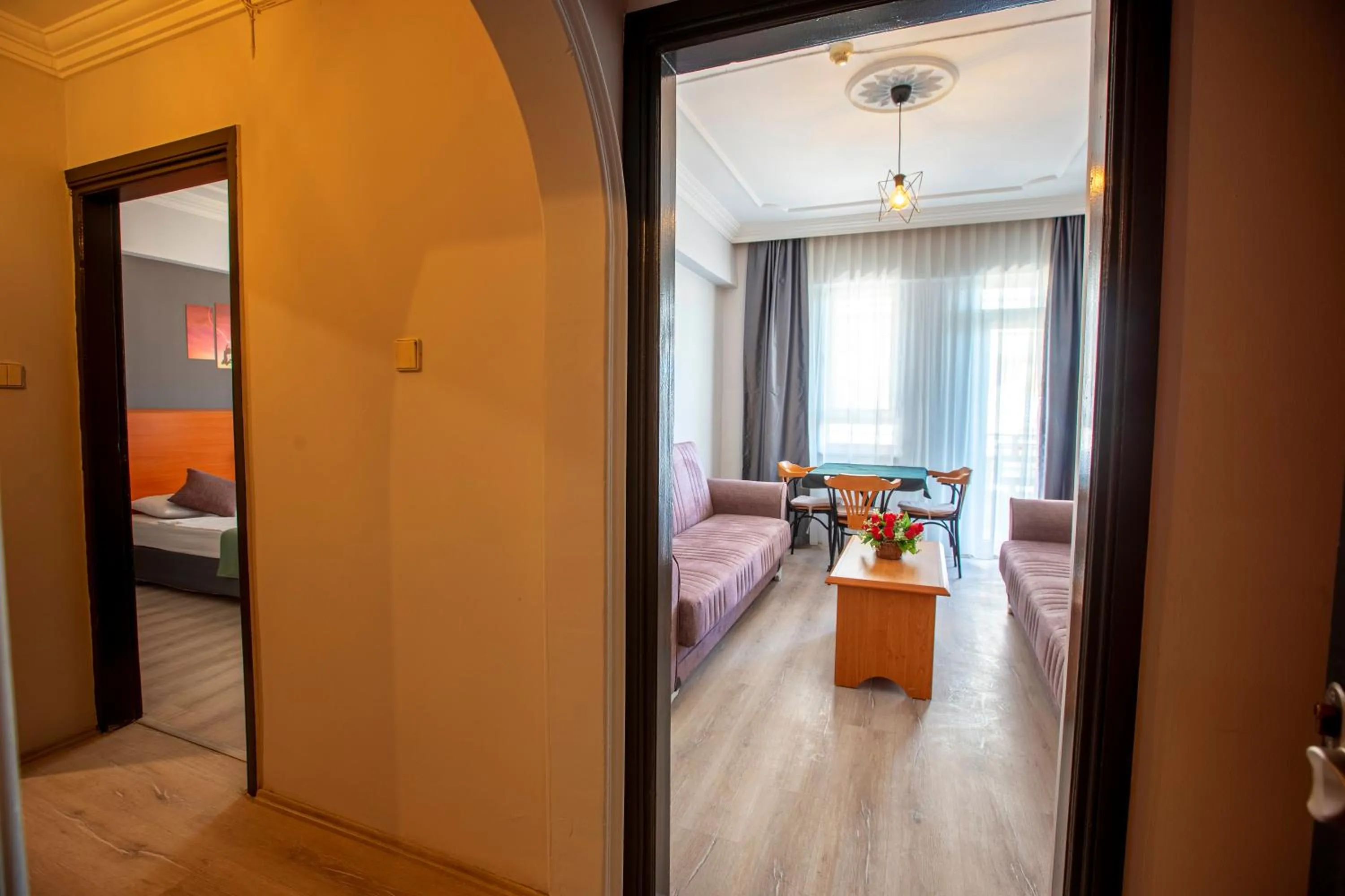 Living room, Bed in HMA Hotel & Suites