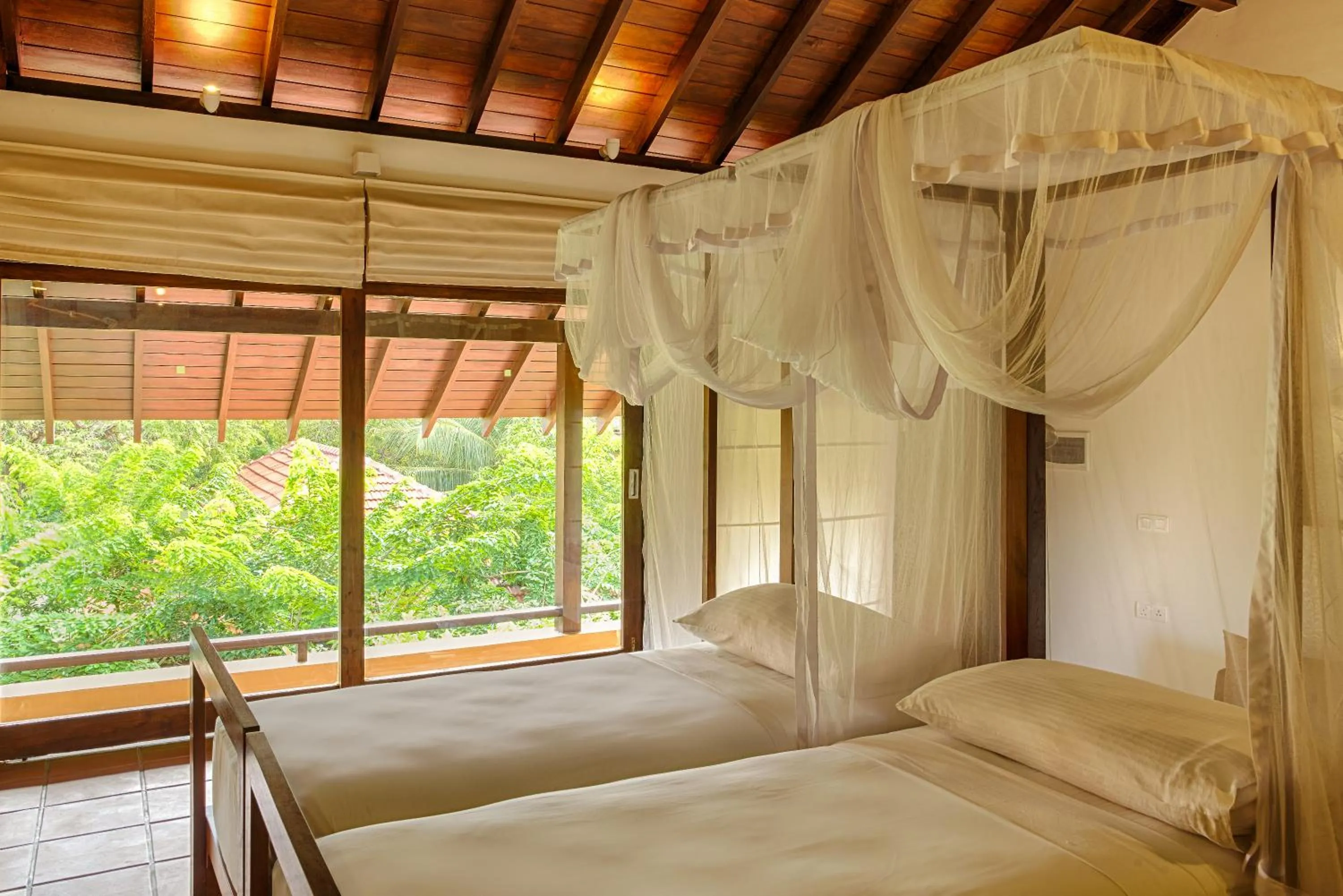 Bed in Jetwing Ayurveda Pavilions