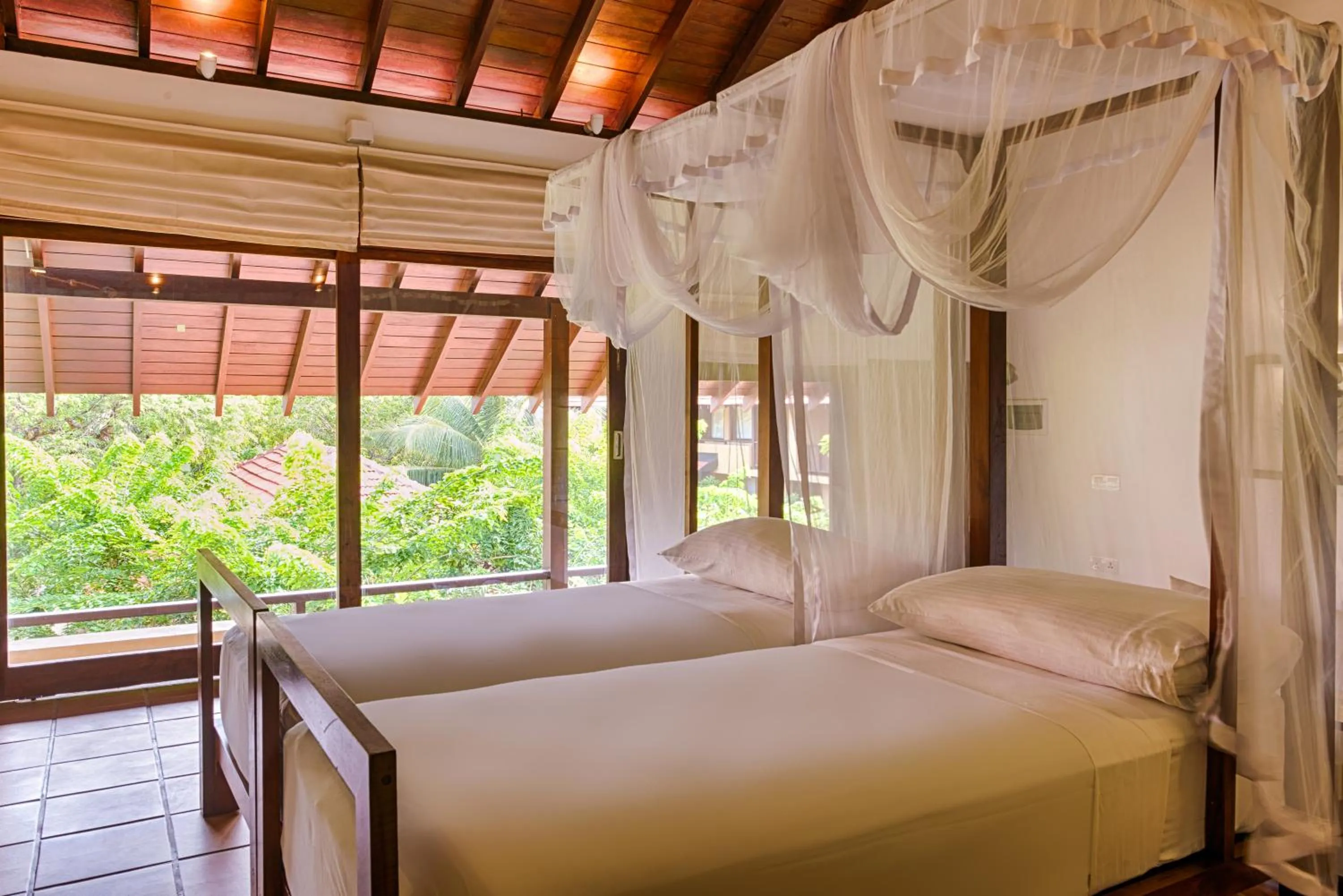 Bed in Jetwing Ayurveda Pavilions