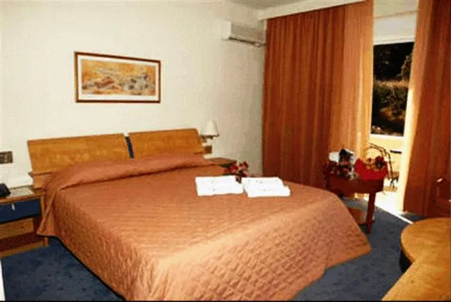 Bed in Crithoni's Paradise Hotel