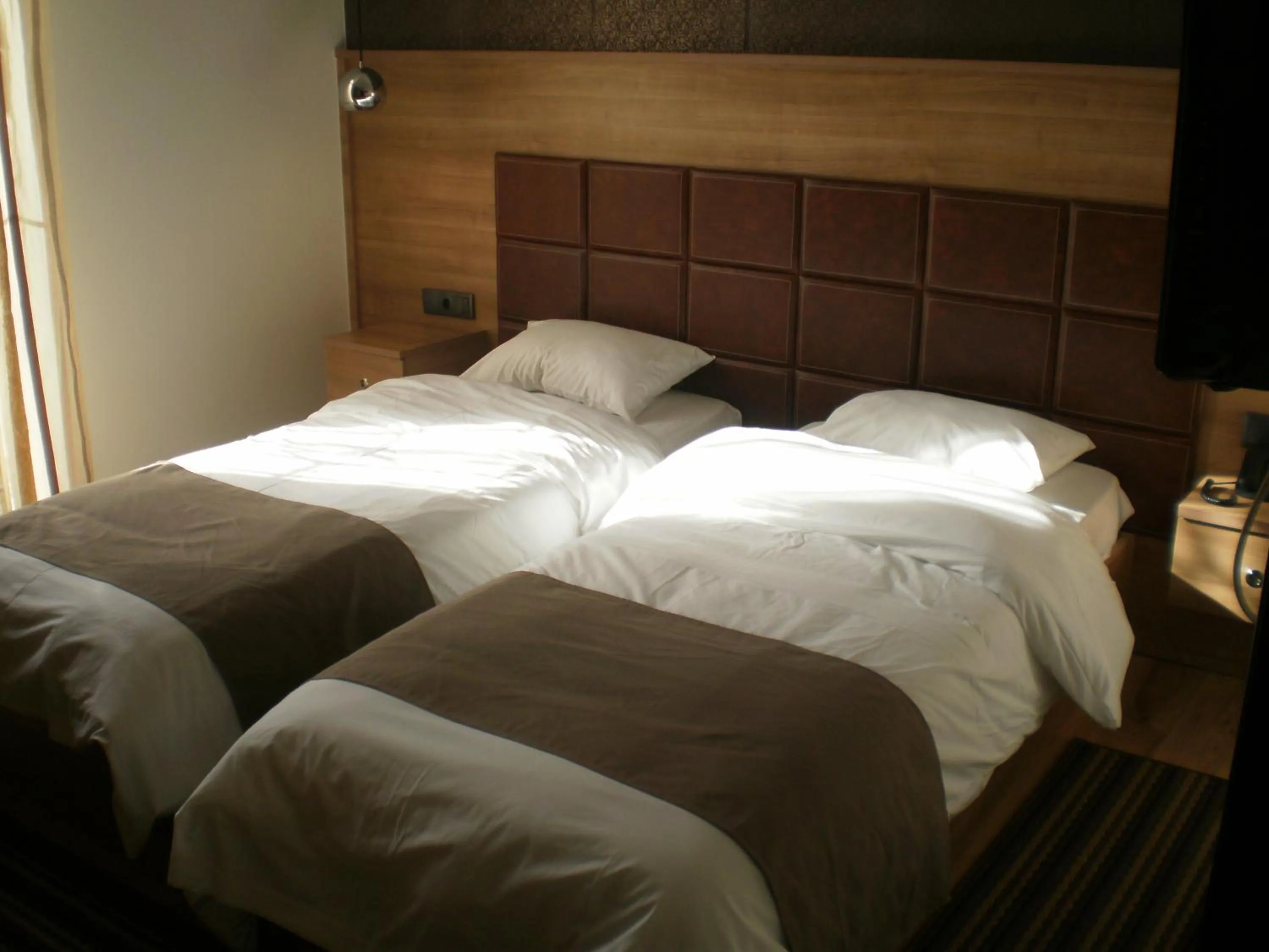 Bed in Metropolis Hotel