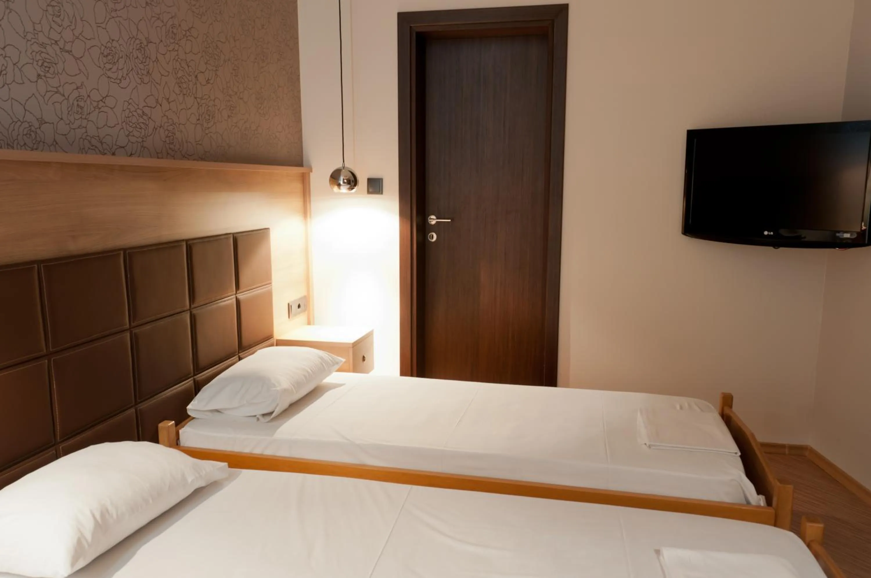 Bed in Metropolis Hotel