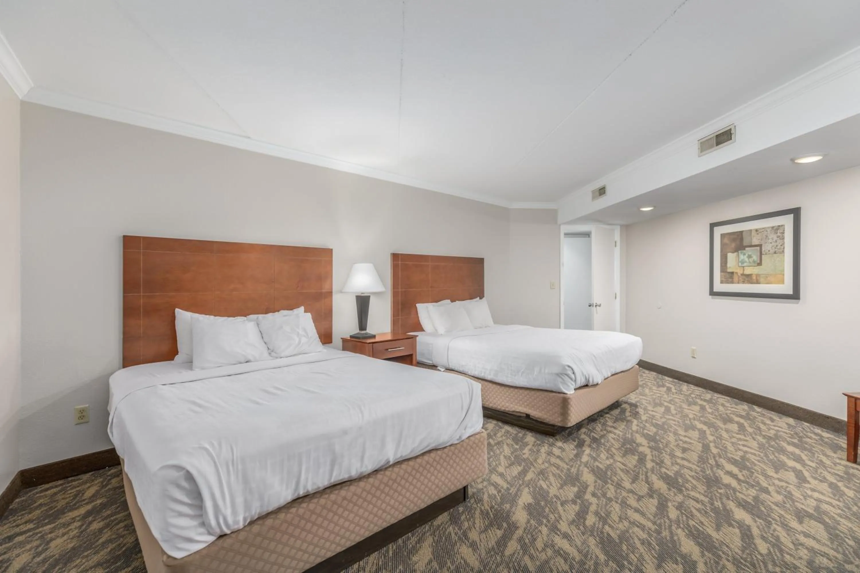 Bed in Crossroads Inn & Suites