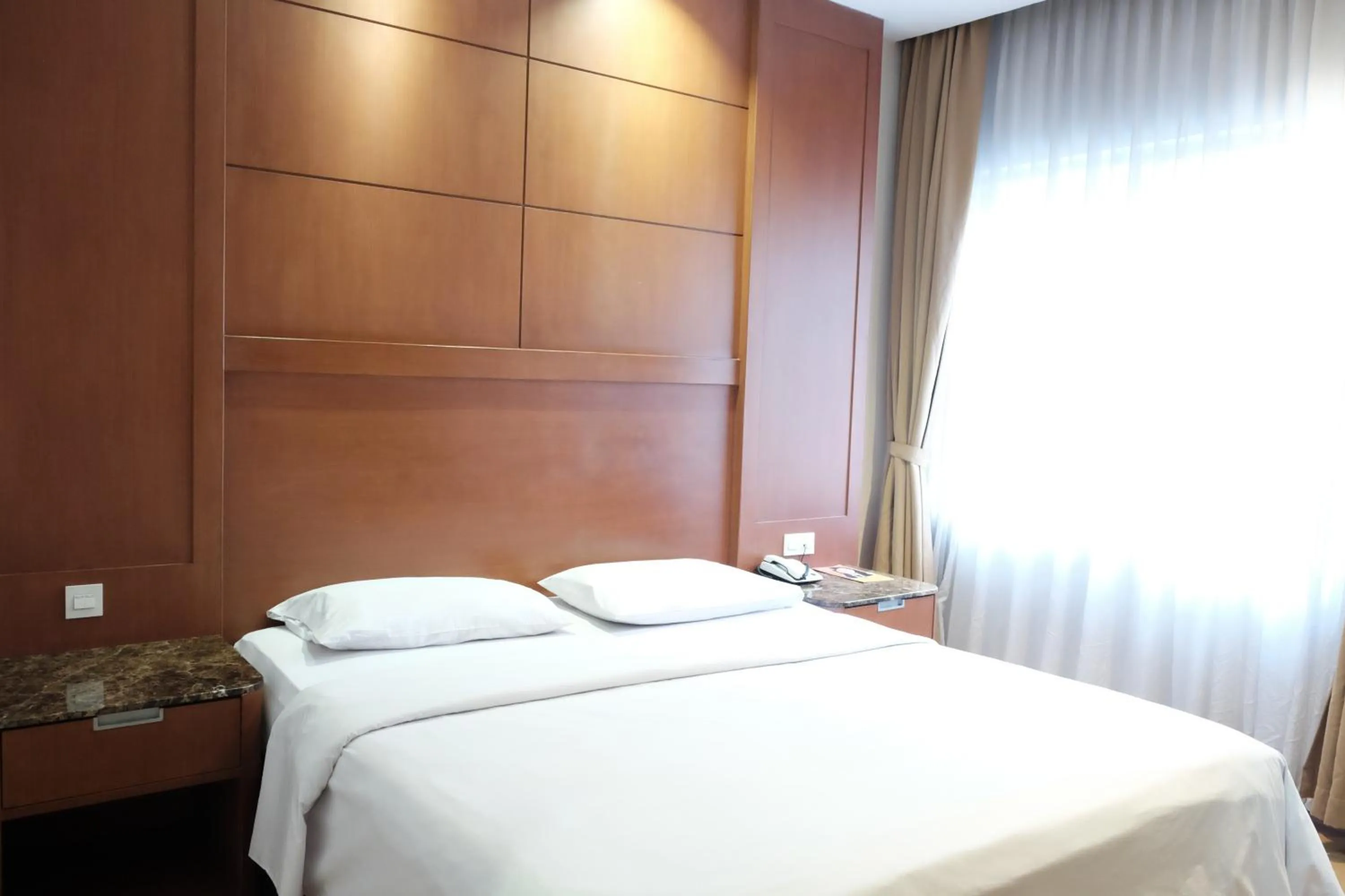 Bed in Grand Sakura Hotel