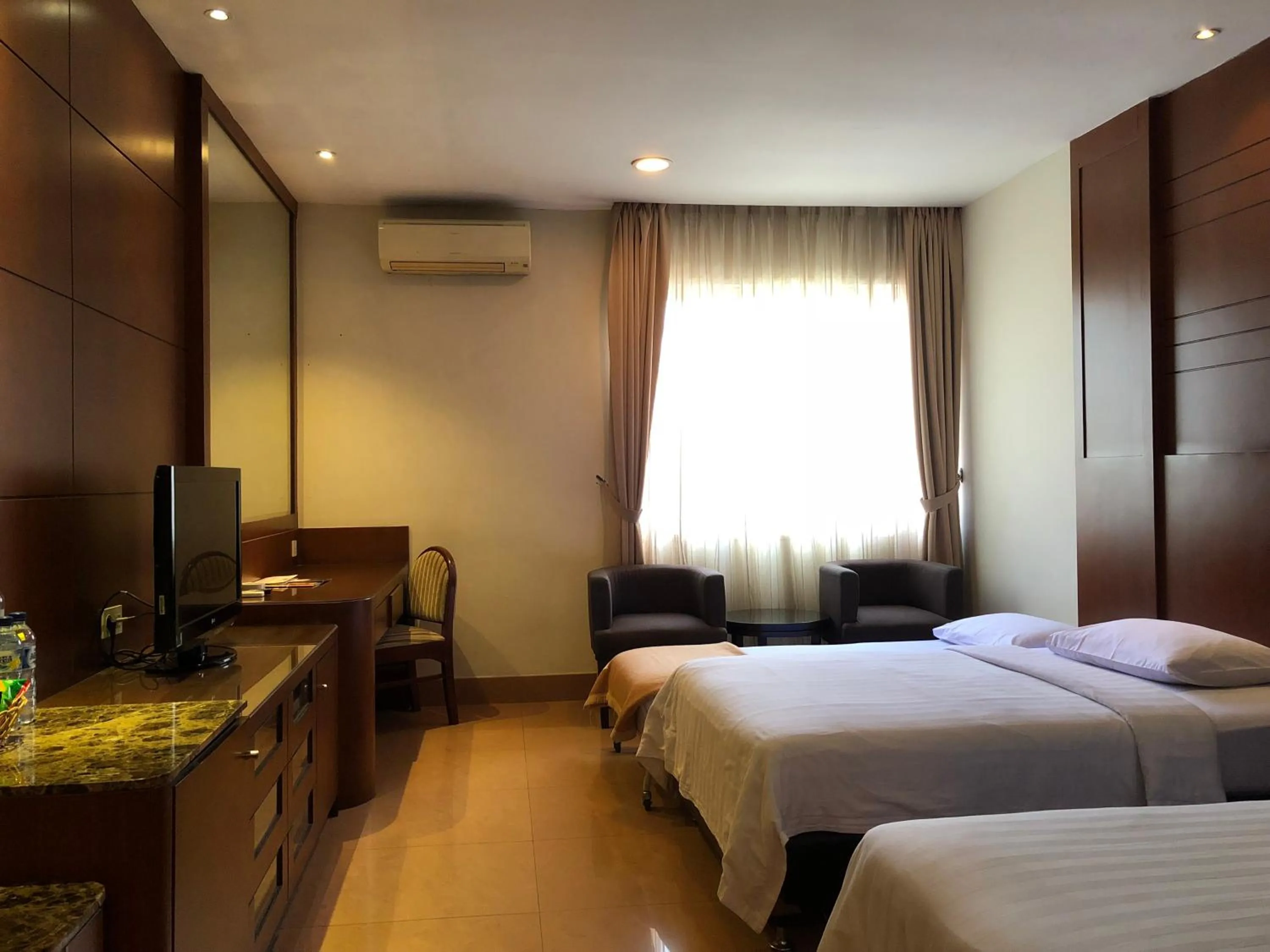 Bed in Grand Sakura Hotel