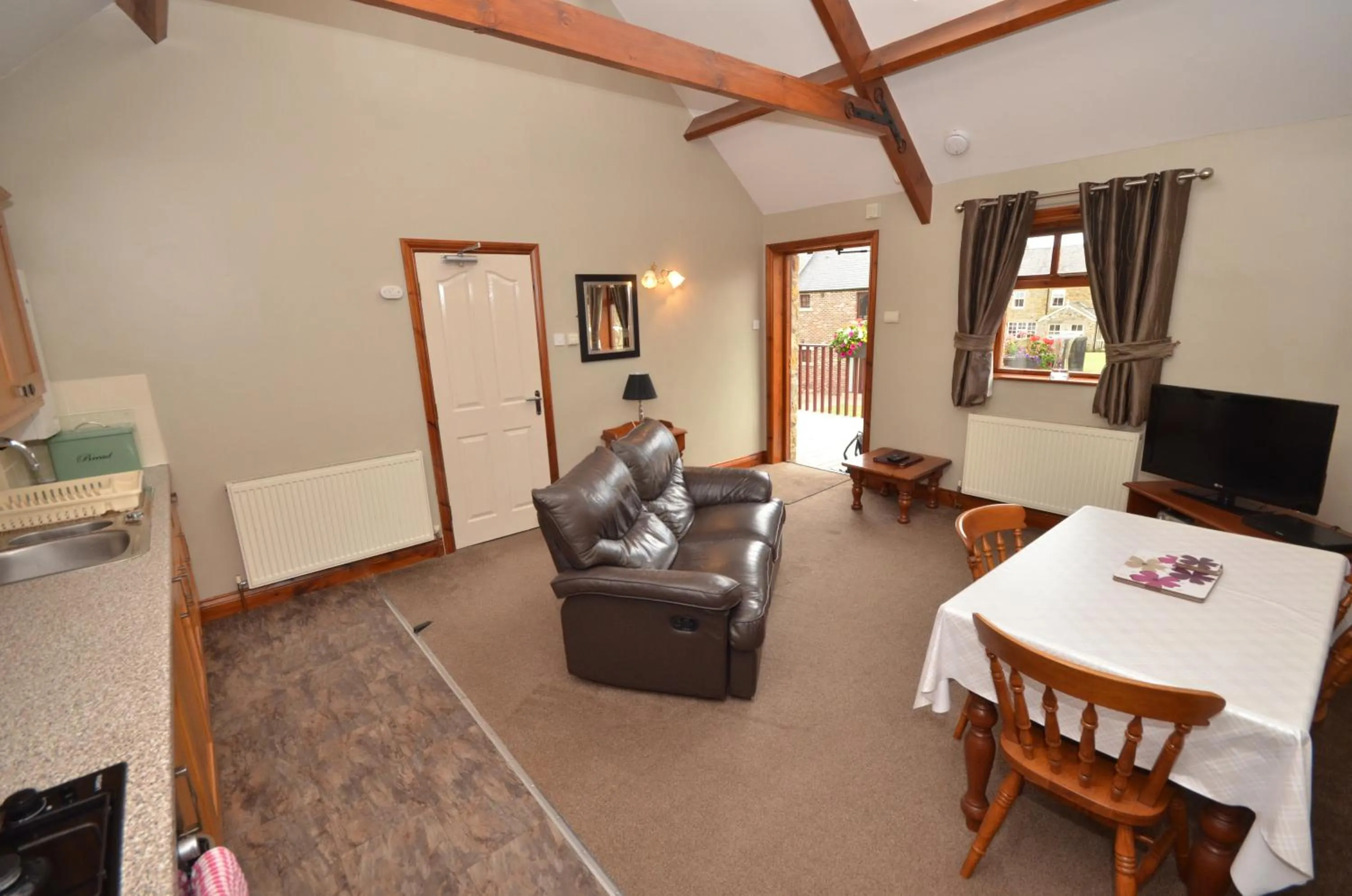 Living room, Bed in Plawsworth Hall Serviced Cottages and Apartments
