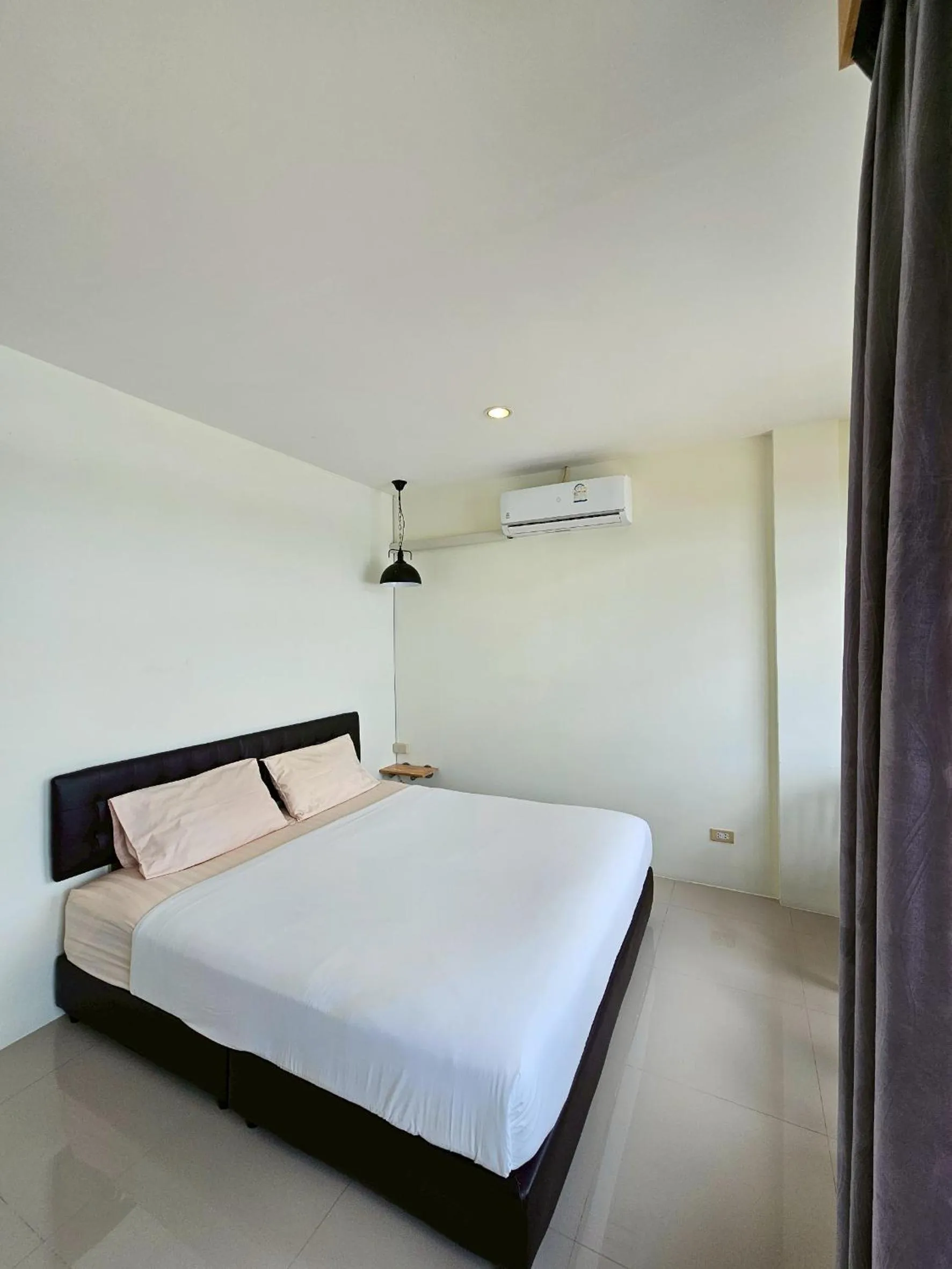 Bed in Dwell Phuket Airport Hotel at Naiyang