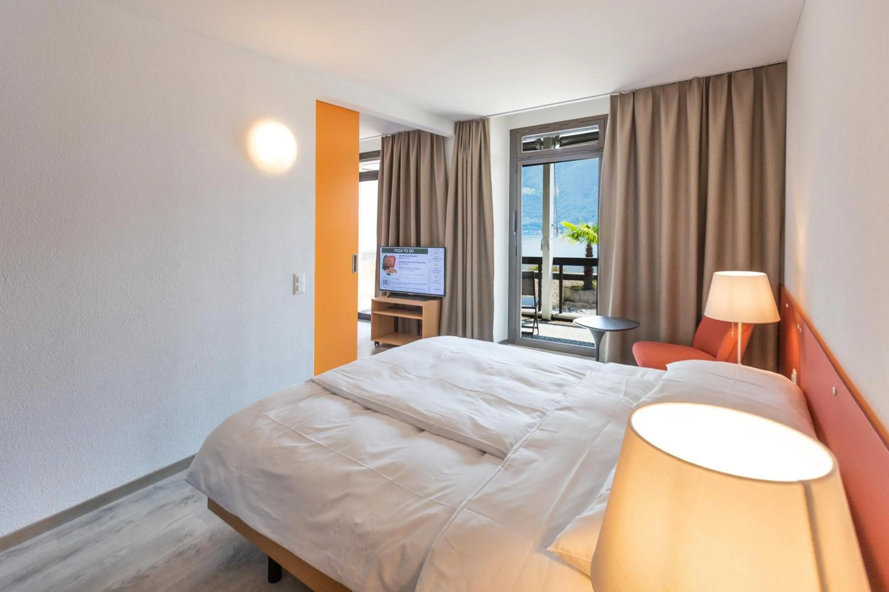 Photo of the whole room, Bed in Parkhotel Brenscino Brissago