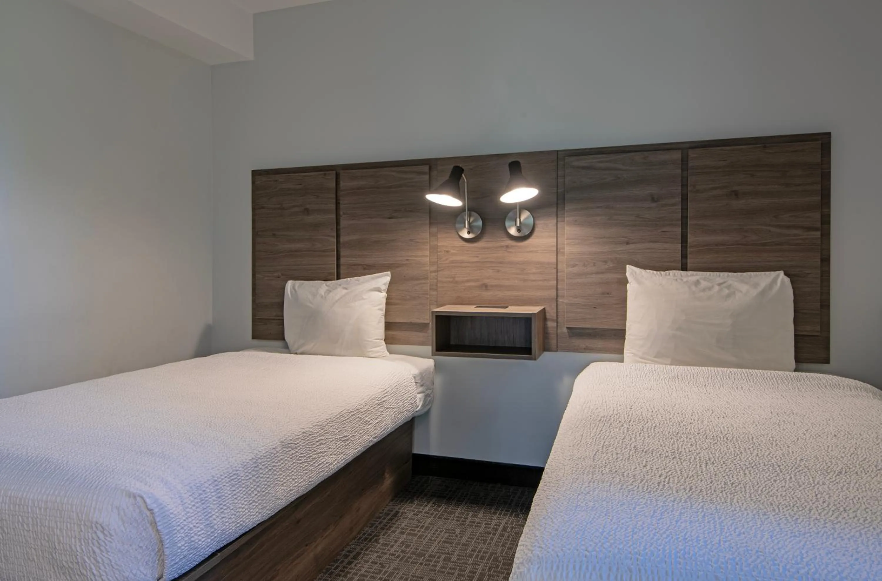 Bed in Riverland Inn & Suites