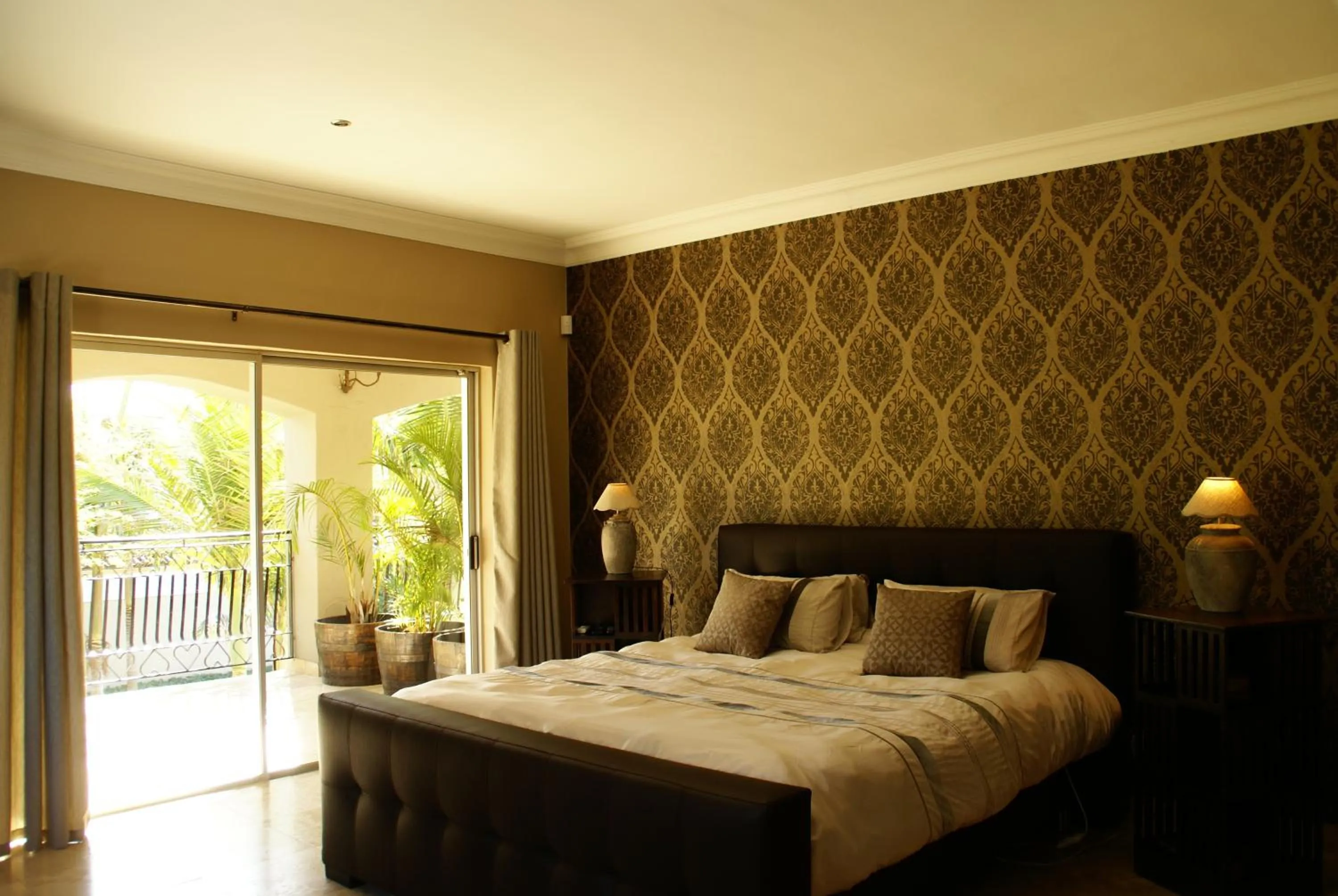 Bedroom in African Palm Cottage and Guesthouse