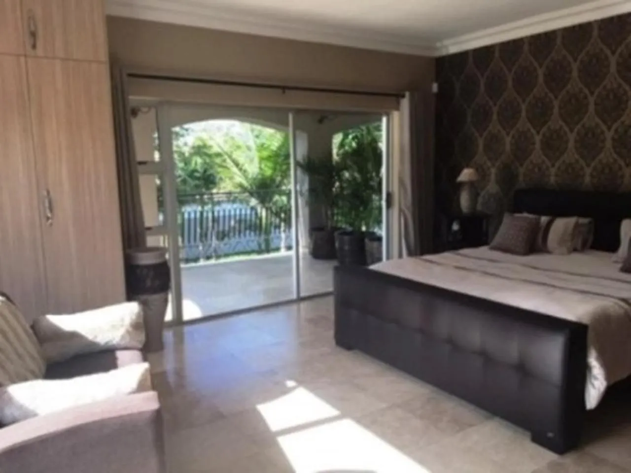 Bedroom in African Palm Cottage and Guesthouse