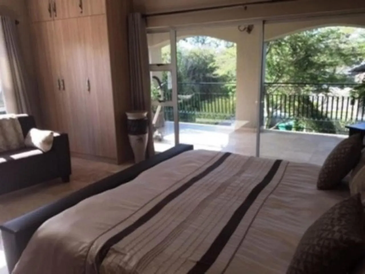 Bedroom in African Palm Cottage and Guesthouse