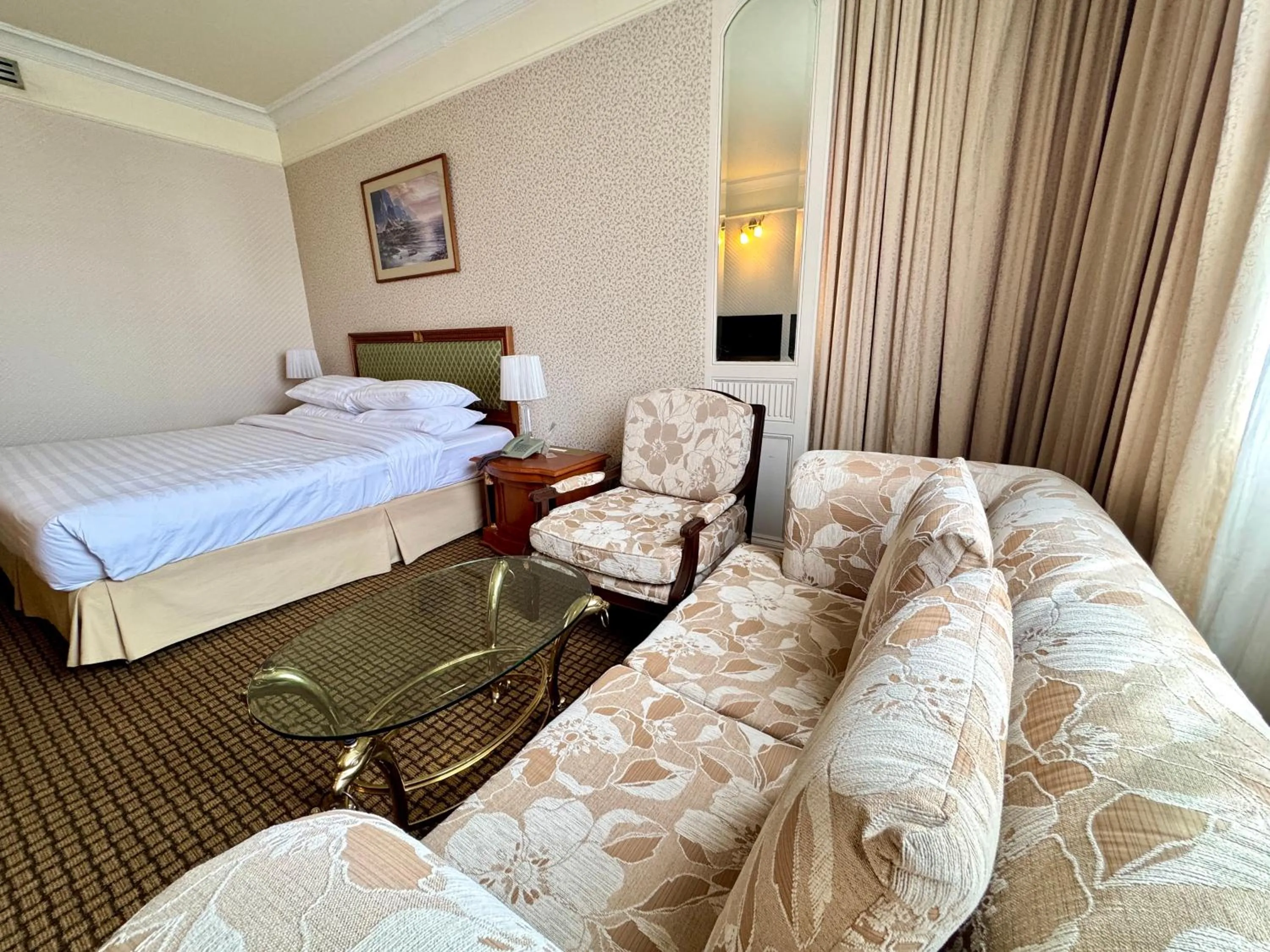 Seating area, Bed in Royal Benja Hotel - Big Room Family-Friendly