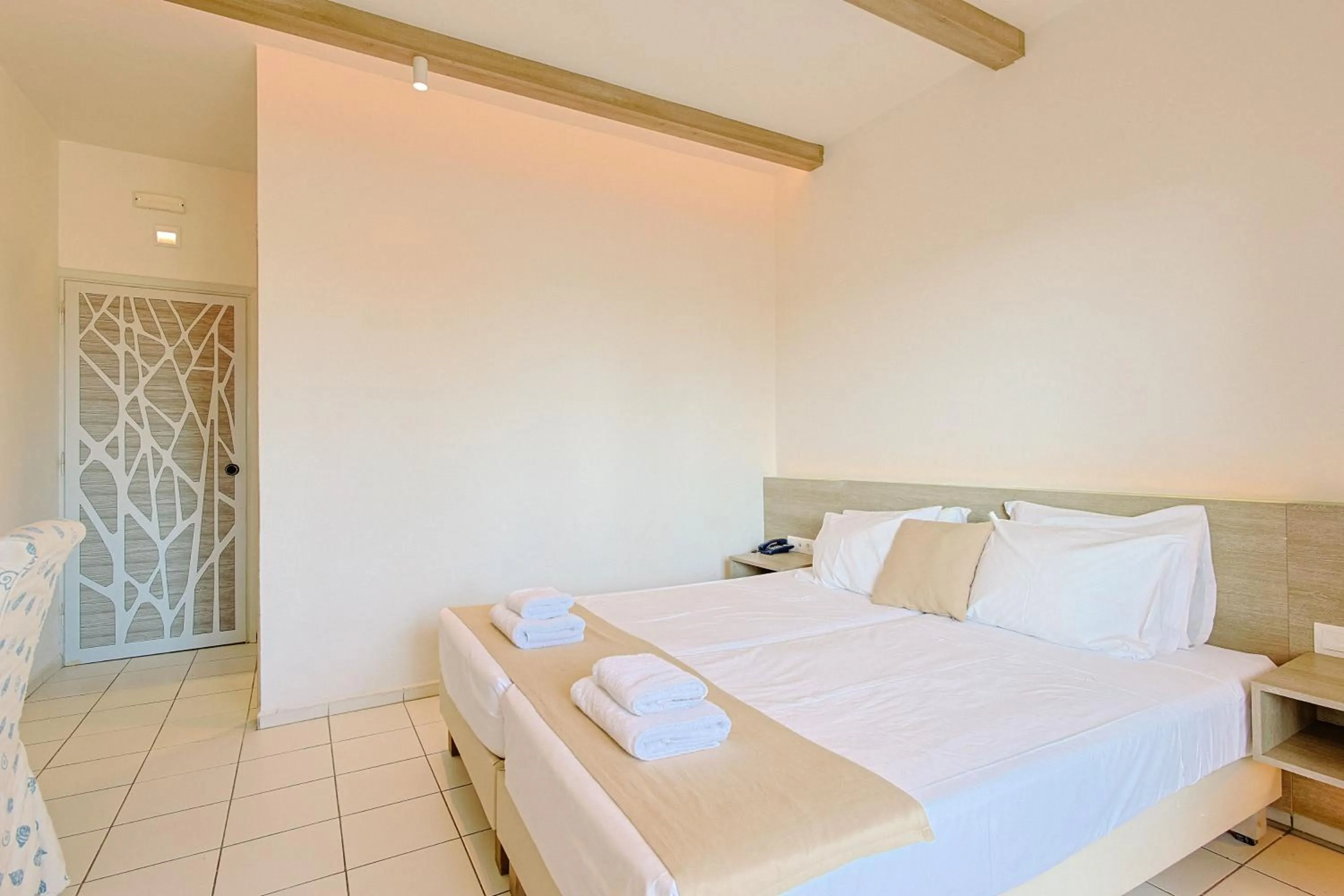 Bed in Porto Greco Village Beach Hotel