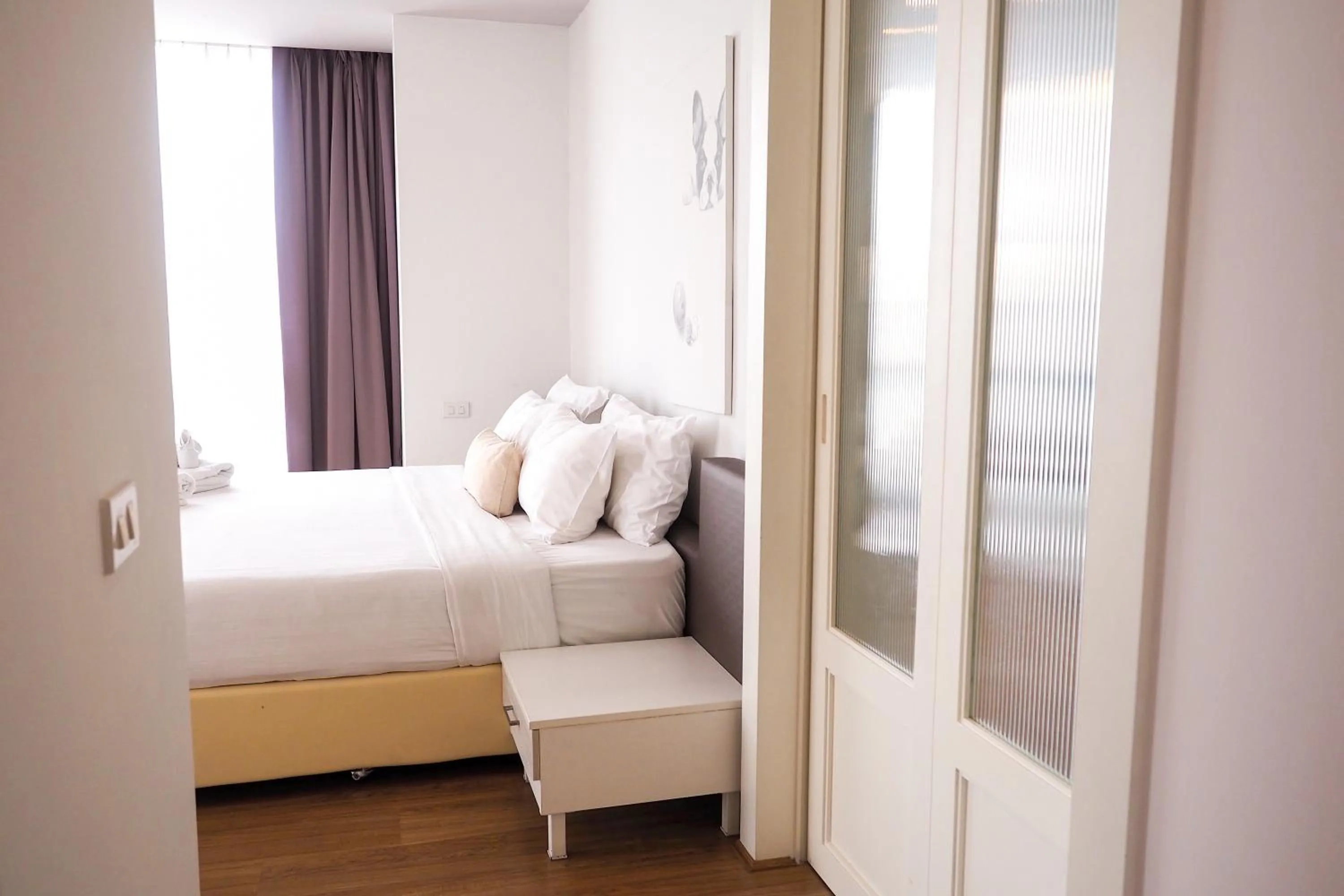 Bed in THE KANNAS Hotel & Serviced Apartment, Chiang Mai SHA Certified