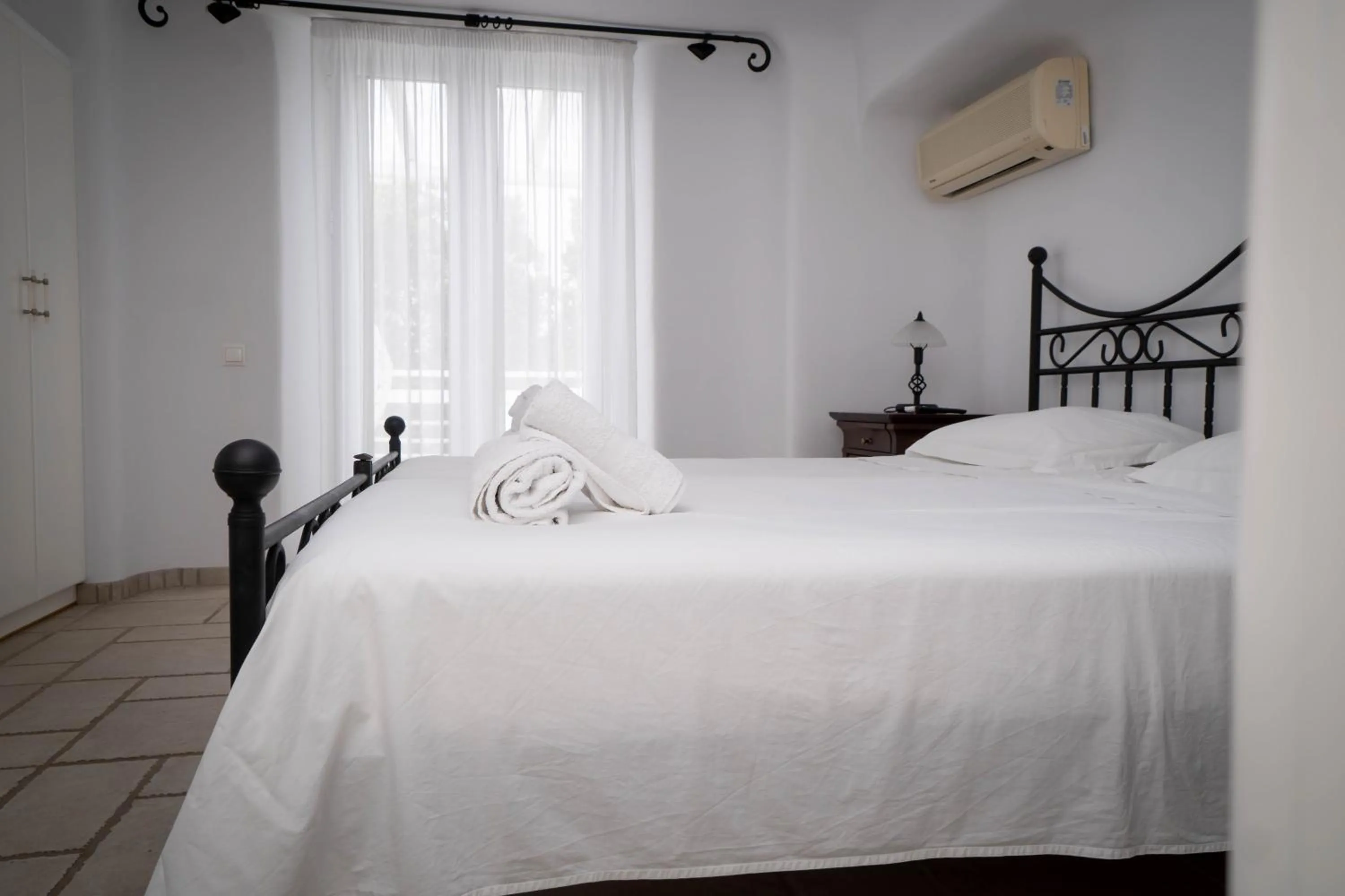 Bed in Mykonian Iros Suites & Villas