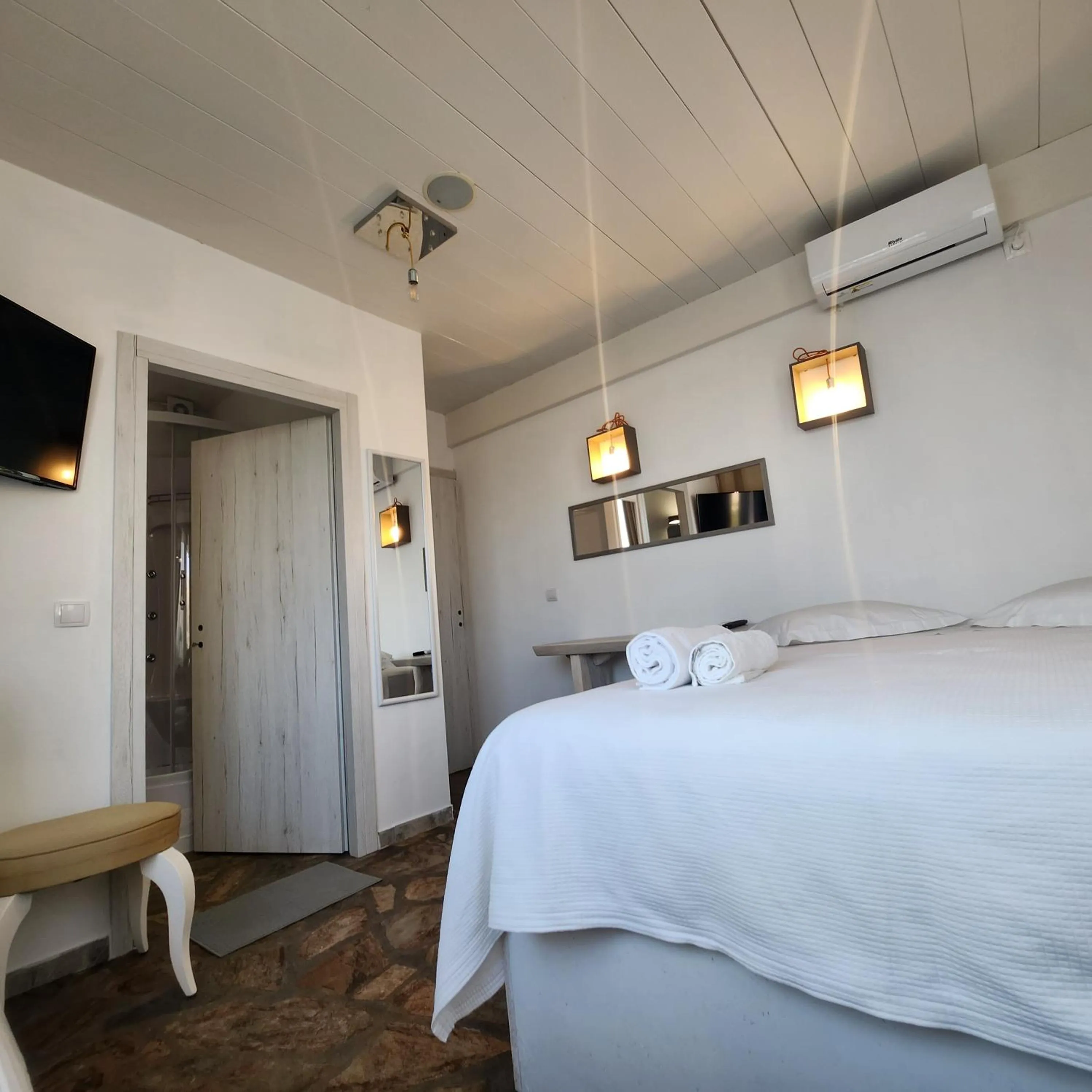 Bed in Mykonian Iros Suites & Villas