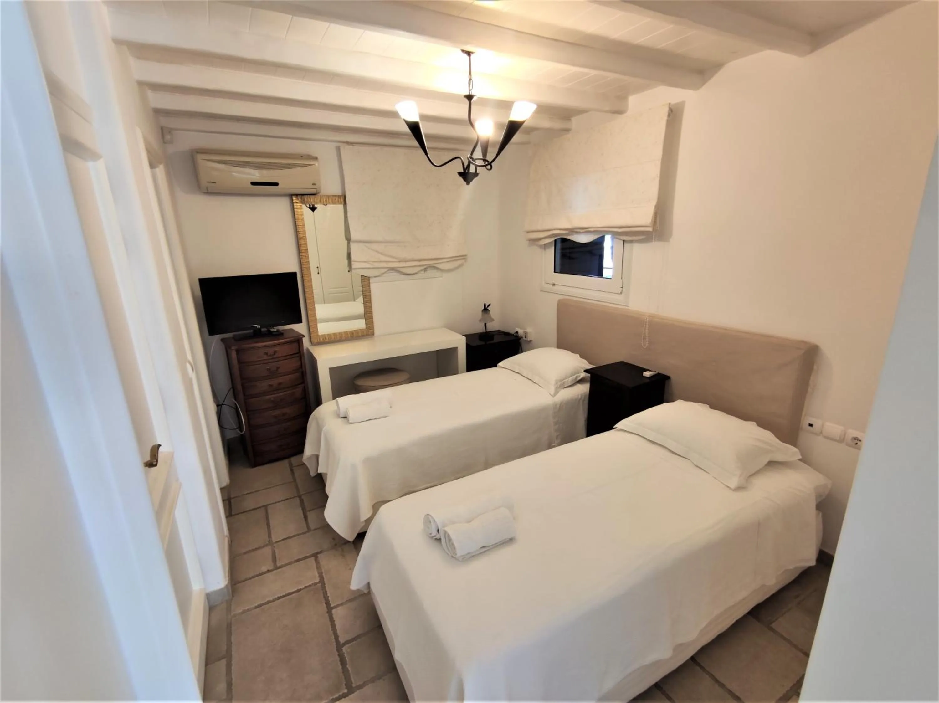 Bed in Mykonian Iros Suites & Villas