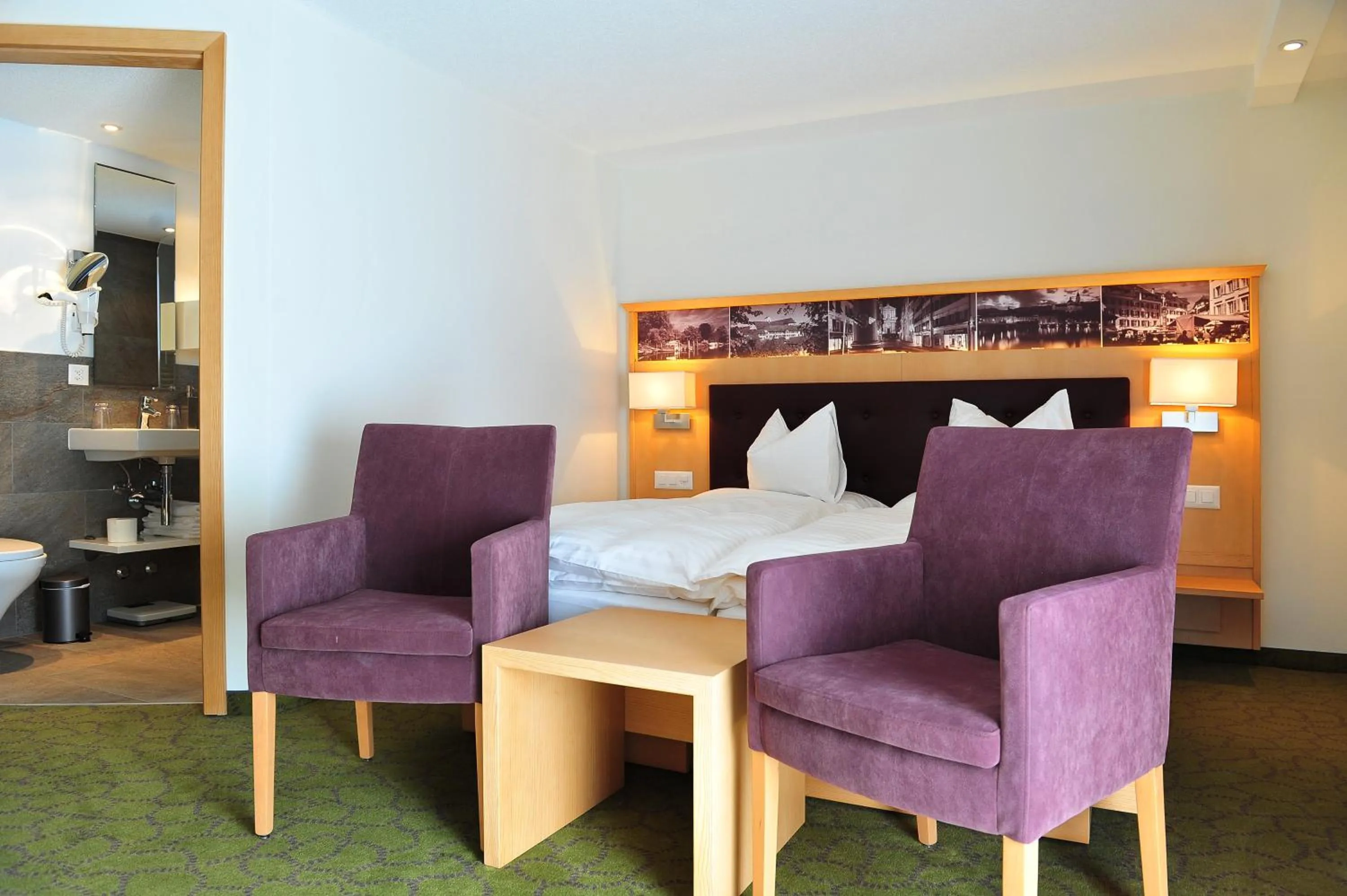 Seating area, Bed in Hotel Aristella Swissflair