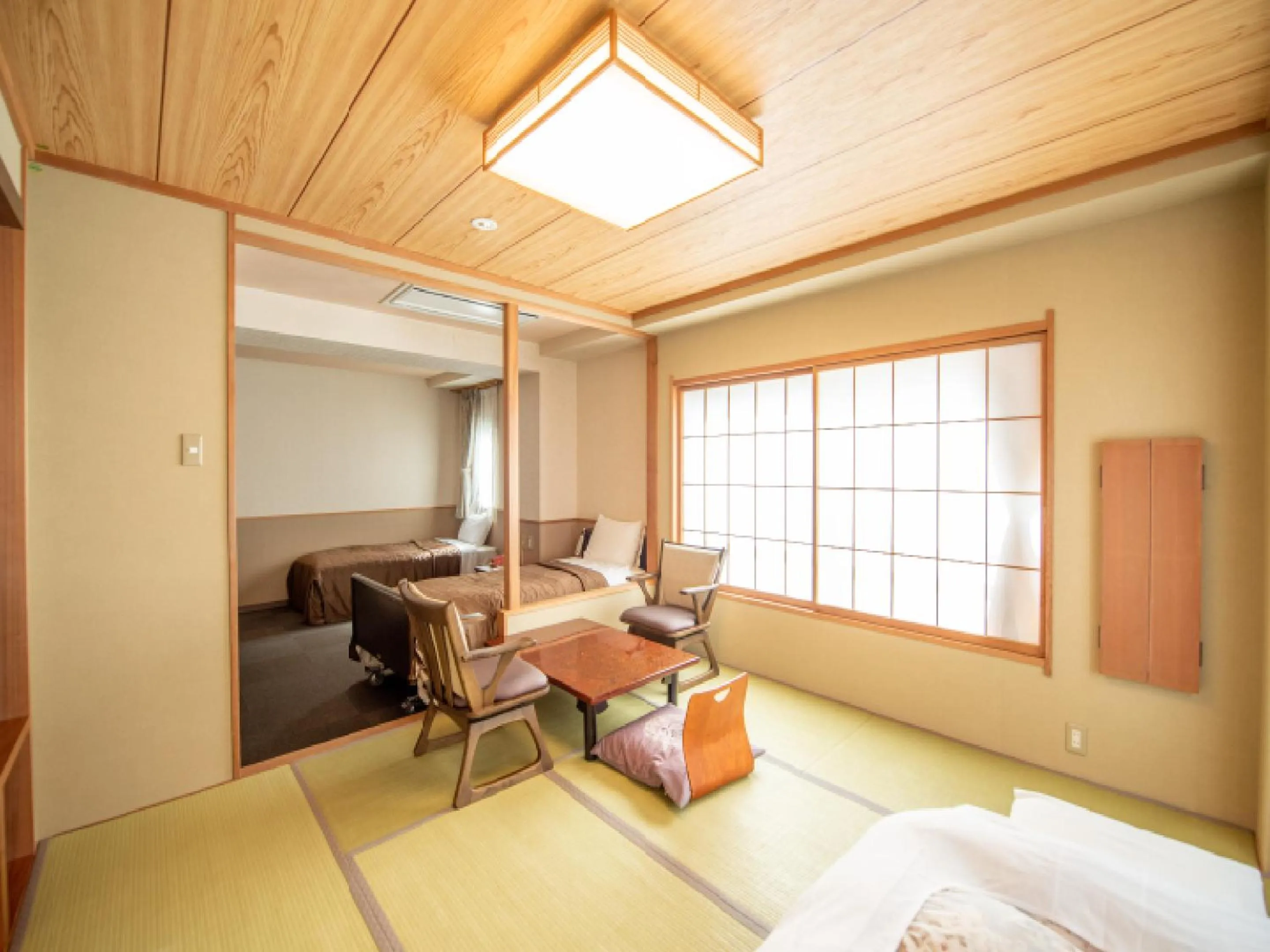 Living room, Bed in Ryokan Hakura