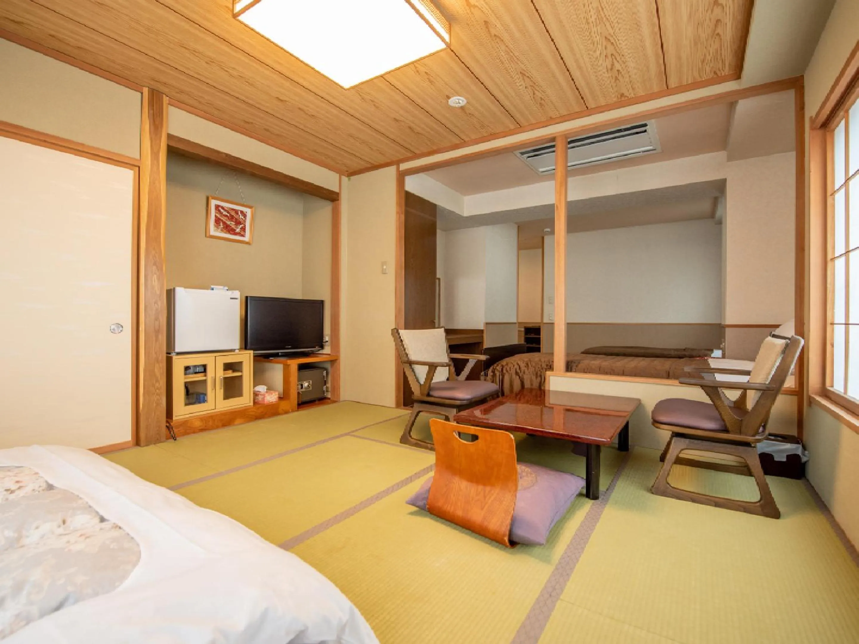 Living room, Bed in Ryokan Hakura