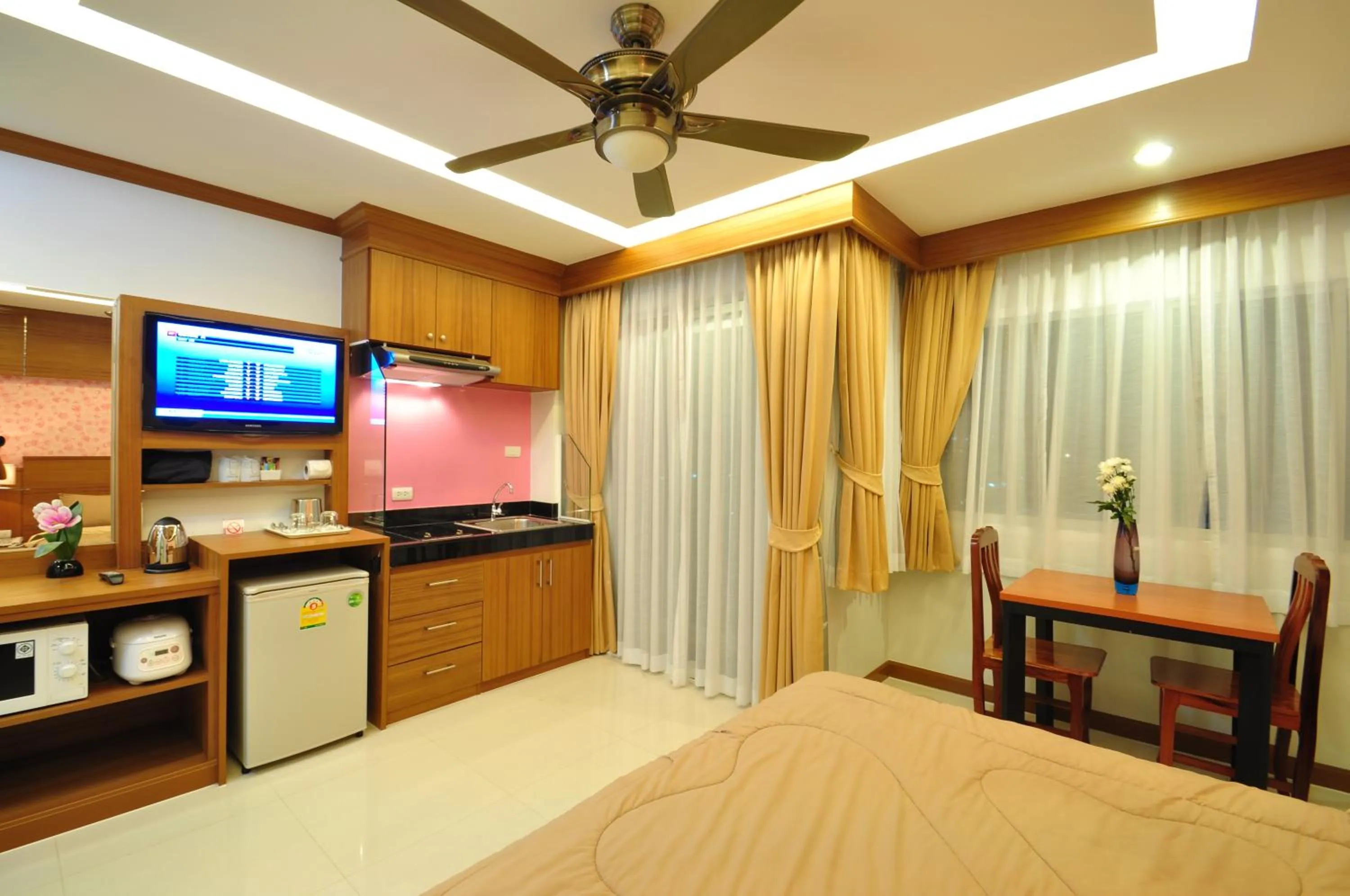 Kitchen or kitchenette, Bed in Green Harbor Hotel & Service Apartment