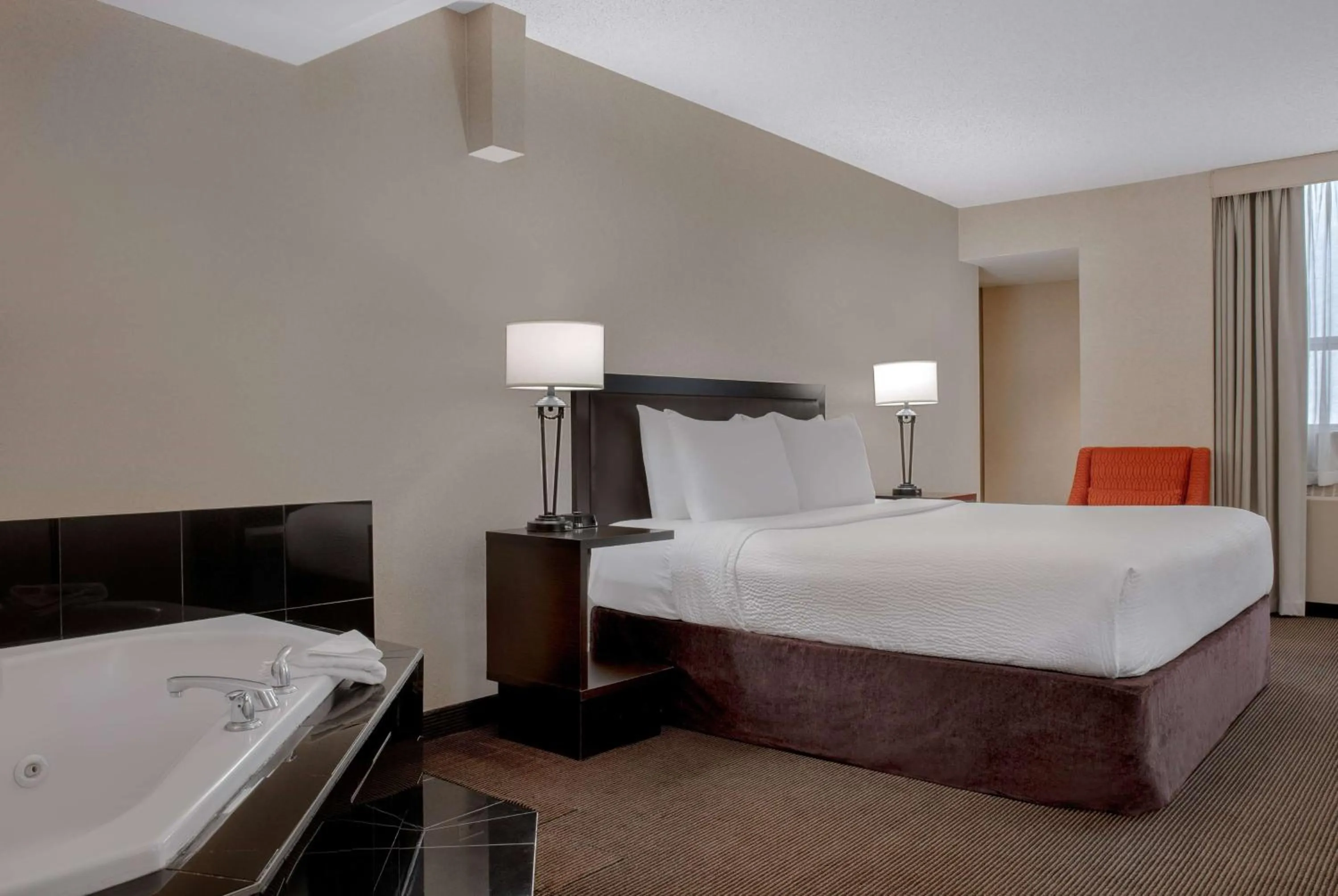 Photo of the whole room, Bed in Ramada Plaza by Wyndham Calgary Downtown