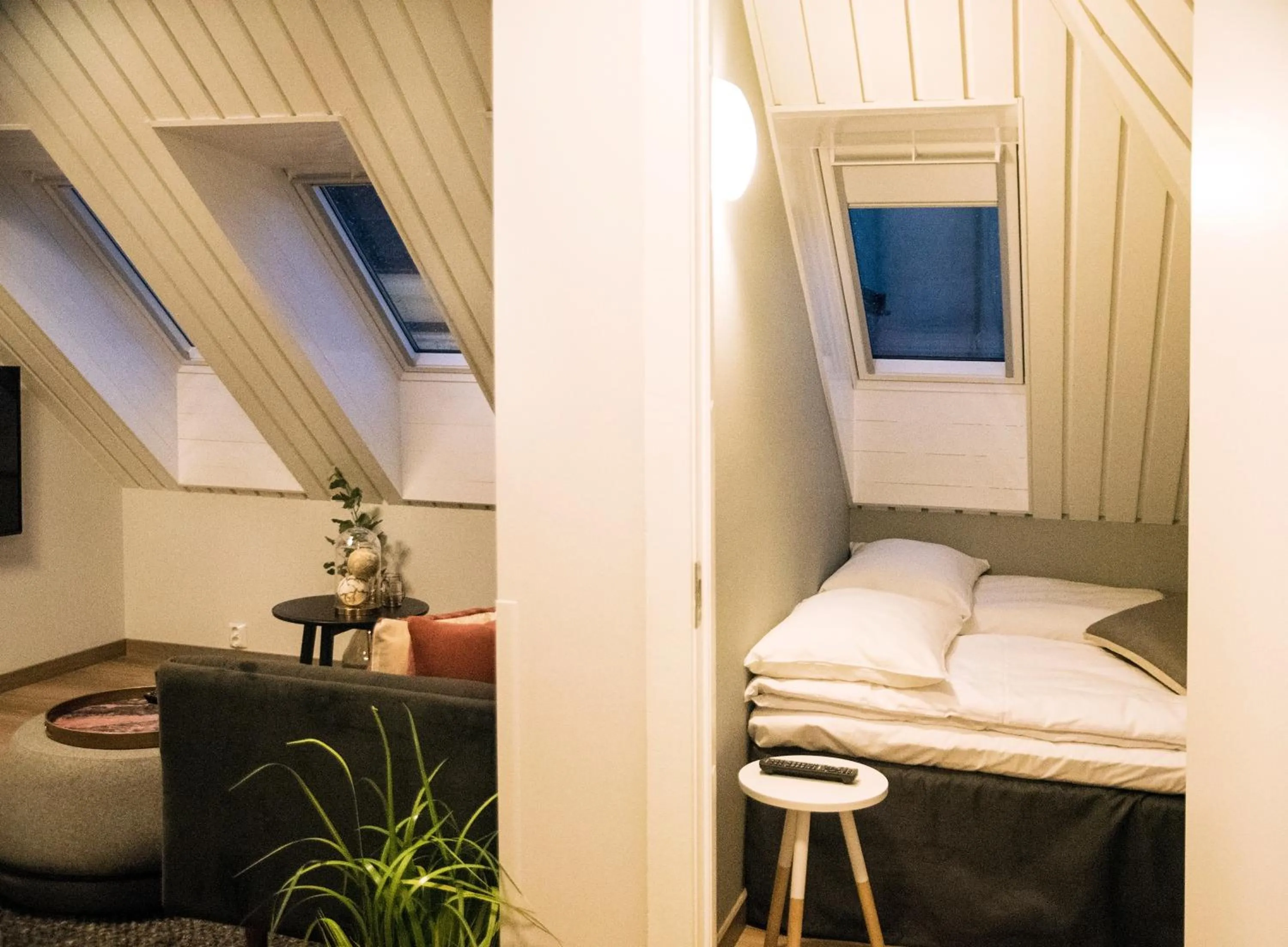 Living room, Bed in Home Again Apartments Nygata 1