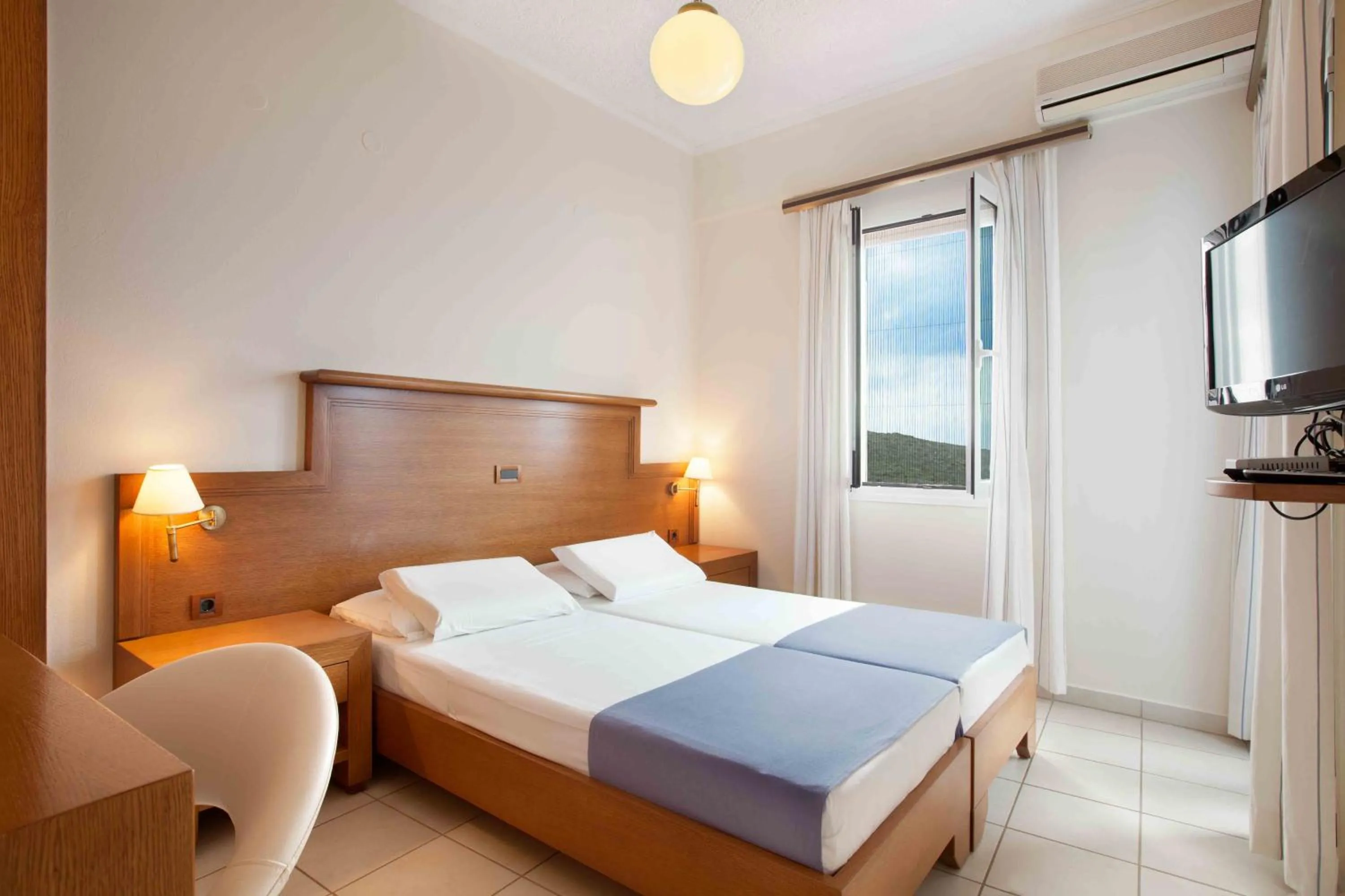 Bed in Giorgi's Blue Apartments