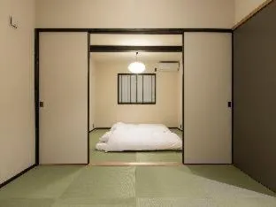 Bed in MUSUBI HOTEL MACHIYA Haruyoshi