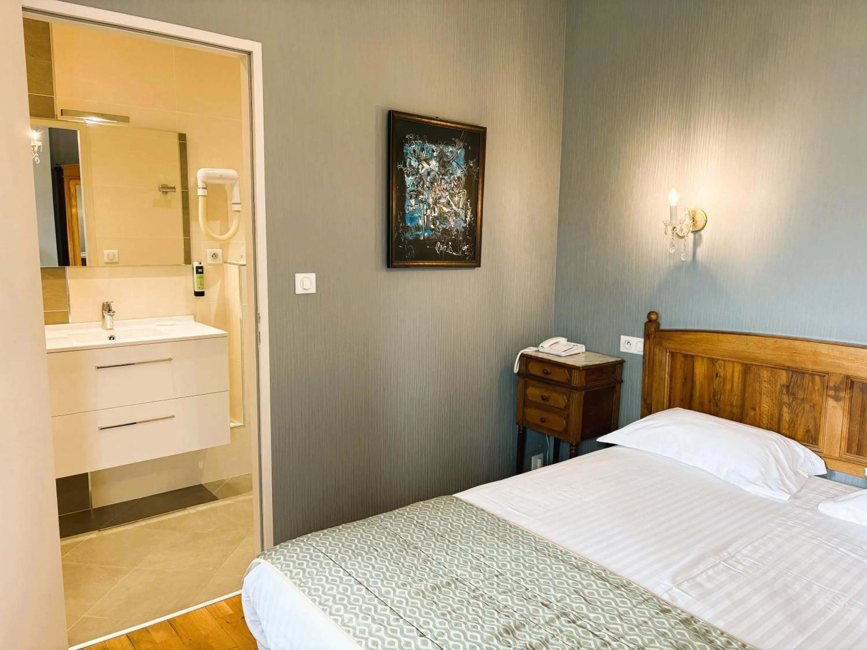 Bed in Logis Hôtel Beau Site