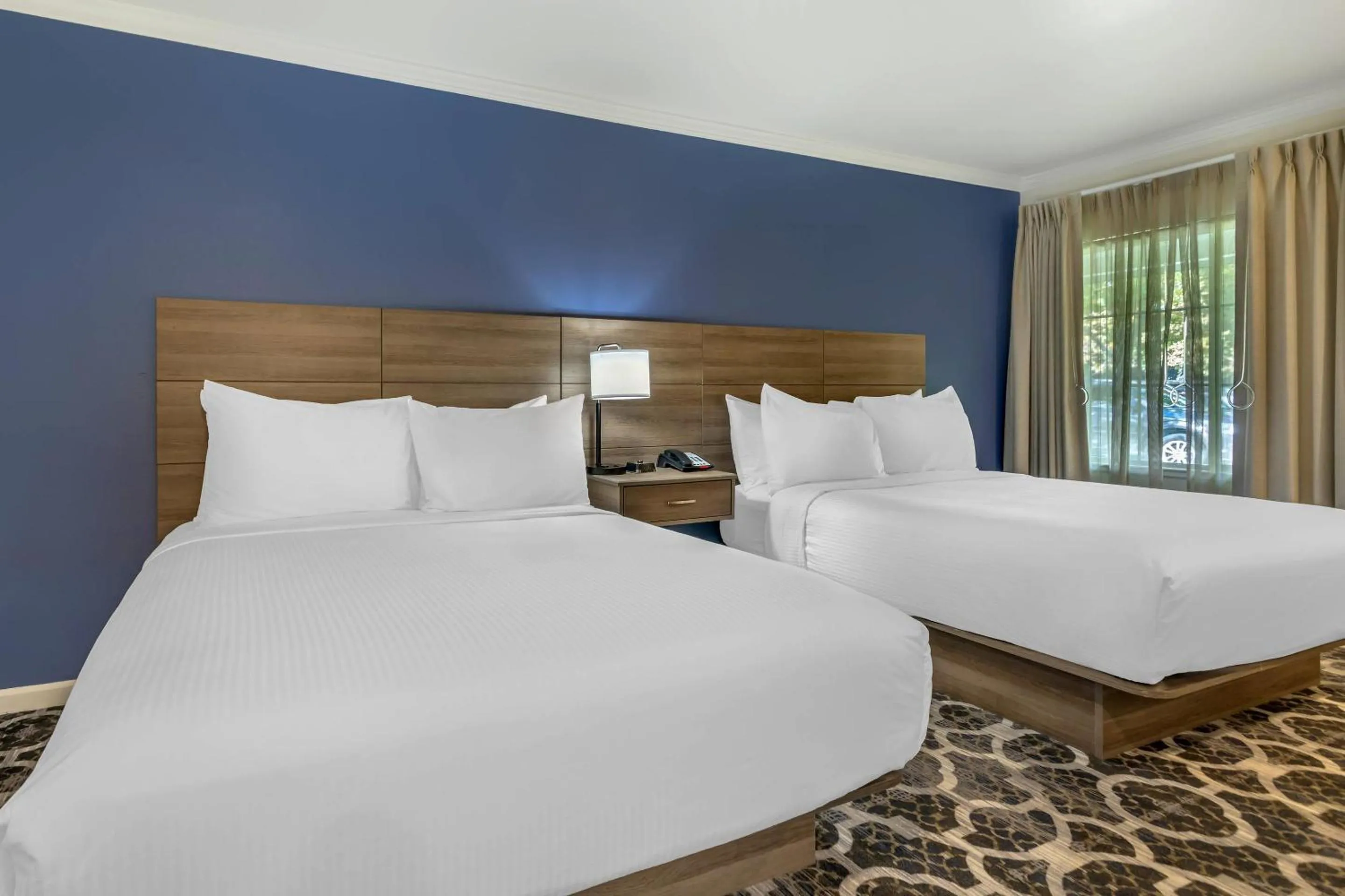 Bedroom, Bed in University Park Inn & Suites, an Ascend Collection Hotel
