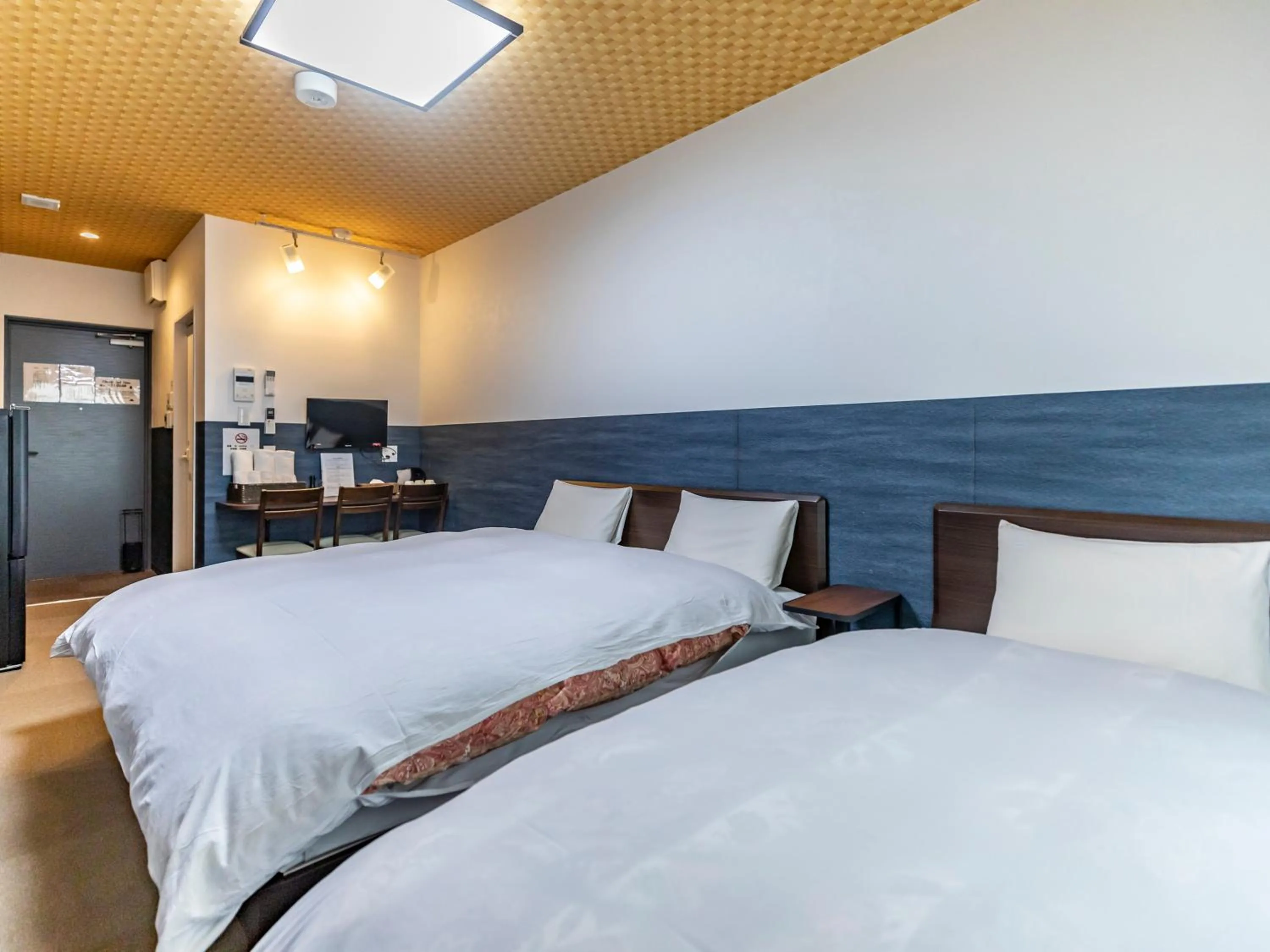 Bed in Tabist Kyogura Kyoto Nijo