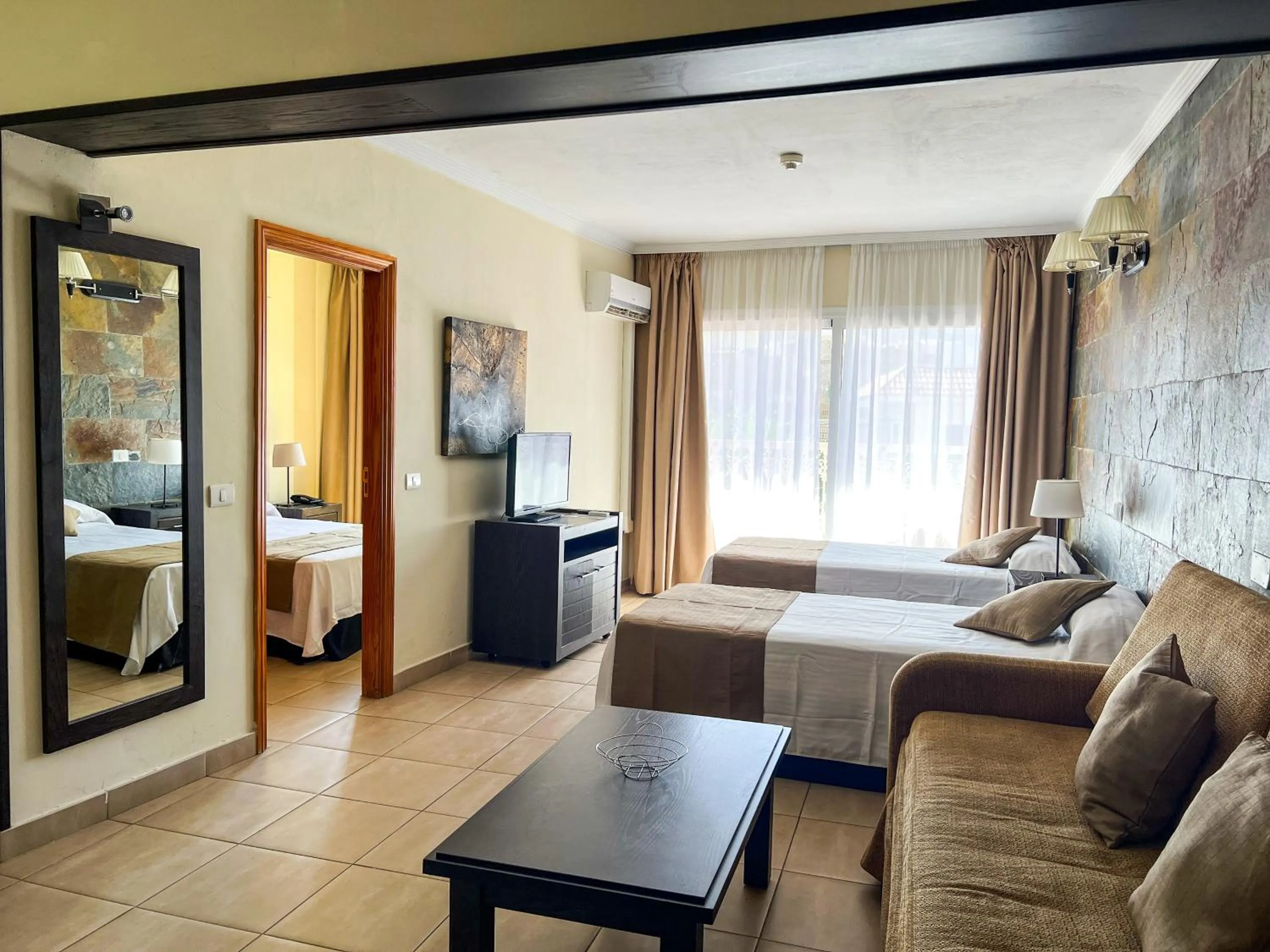 Bed in Hotel La Aldea Suites