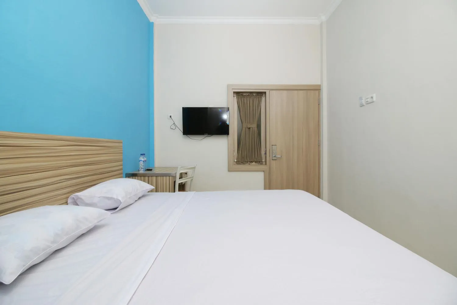 Bed in RedDoorz near Jalan Kolonel Haji Burlian Palembang