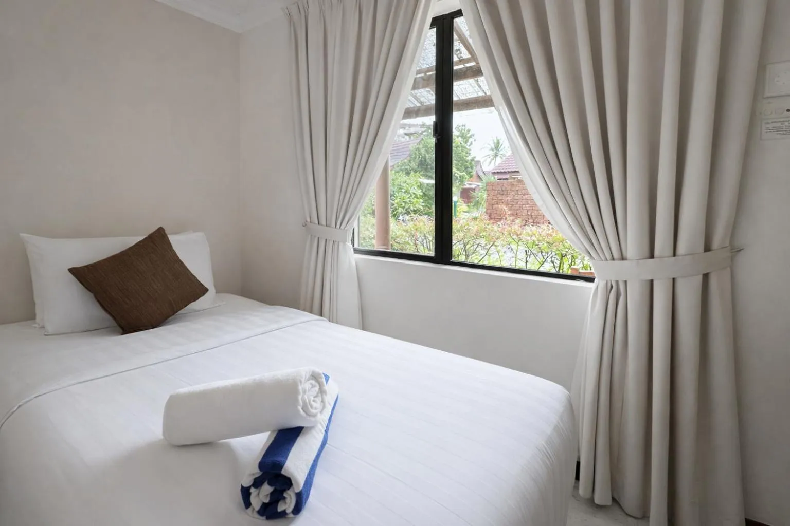 Bed in Frangipani Langkawi Resort