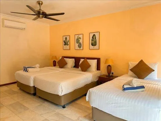 Bed in Frangipani Langkawi Resort