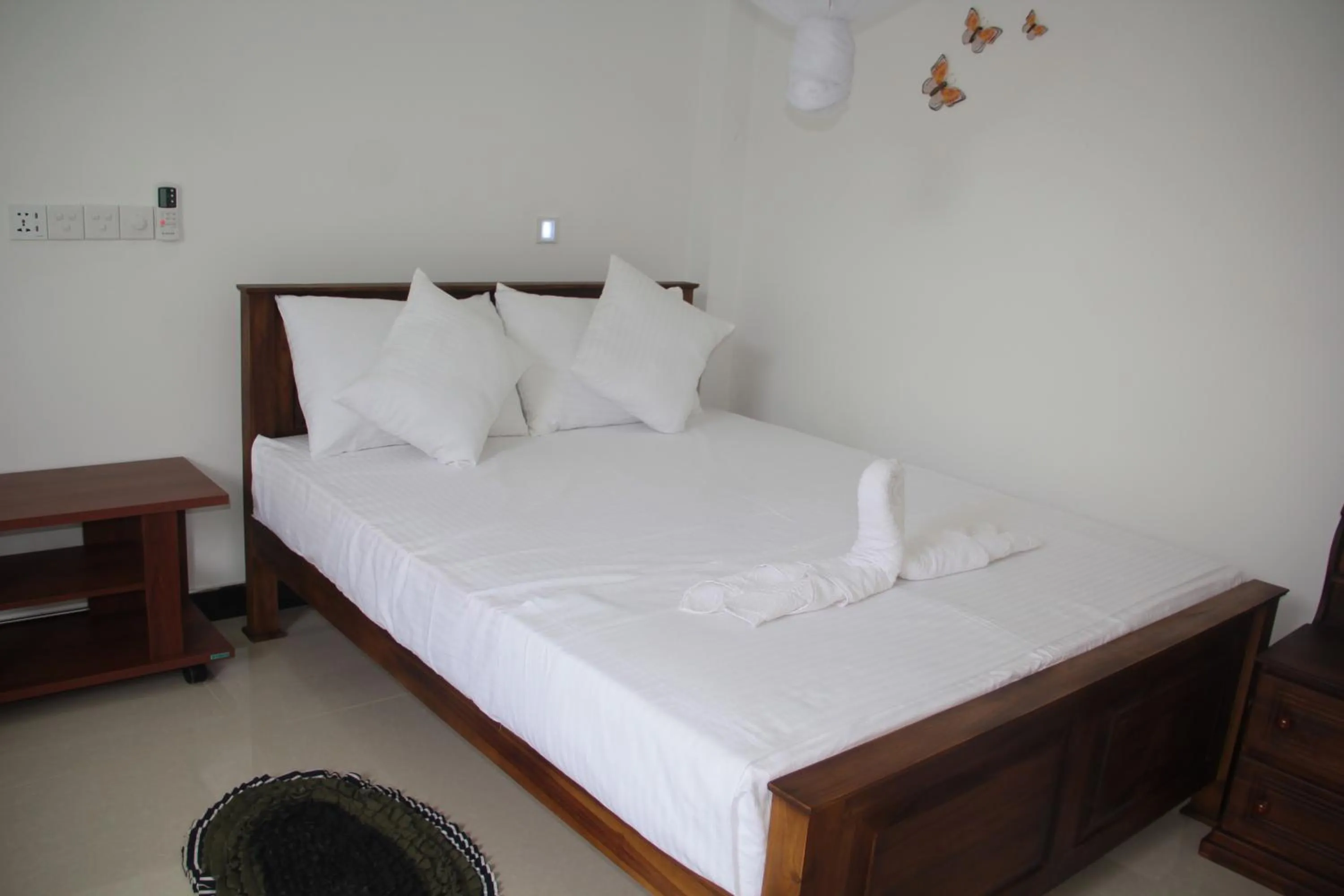 Bed in Butterfly Homestead Hotel