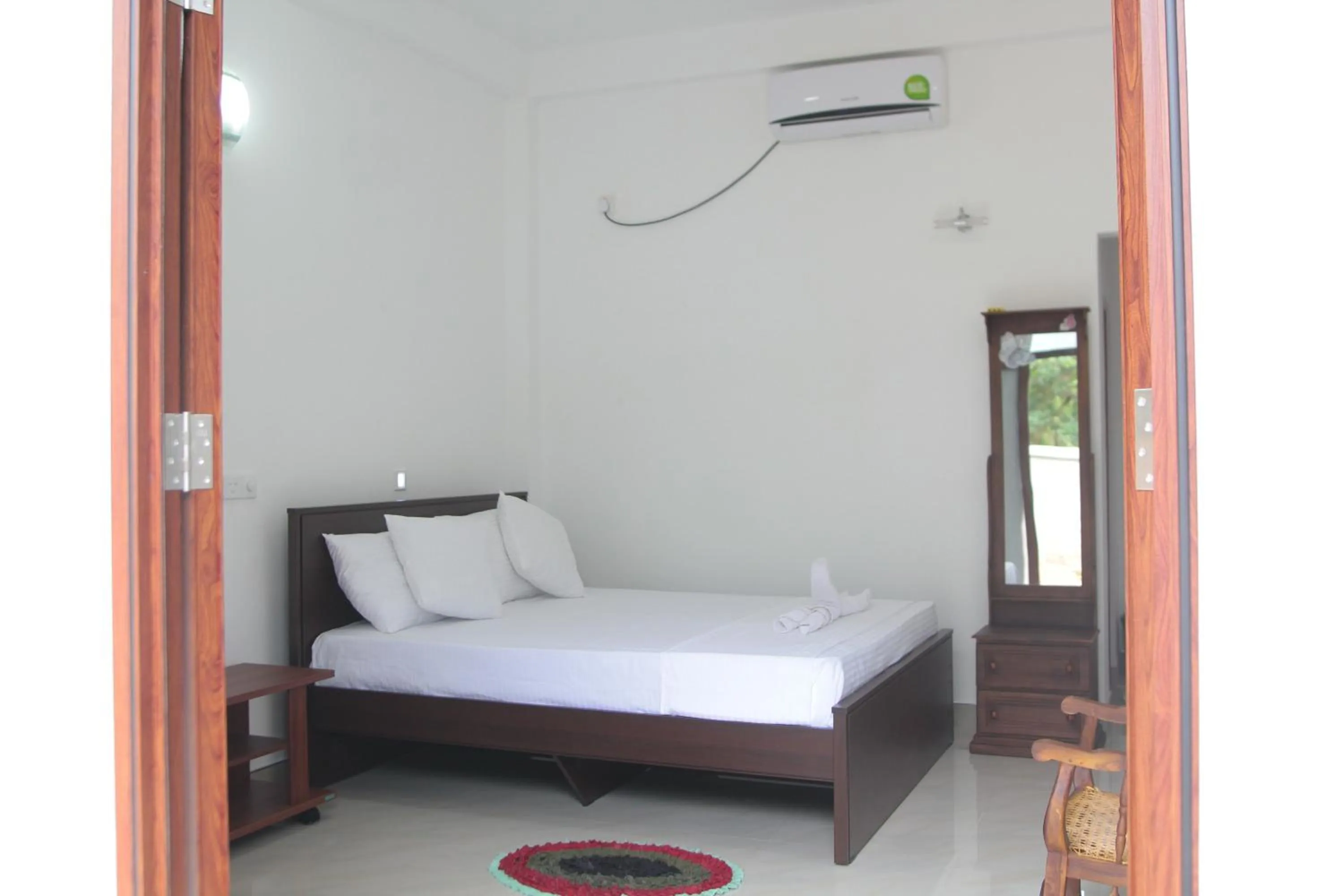 Bed in Butterfly Homestead Hotel