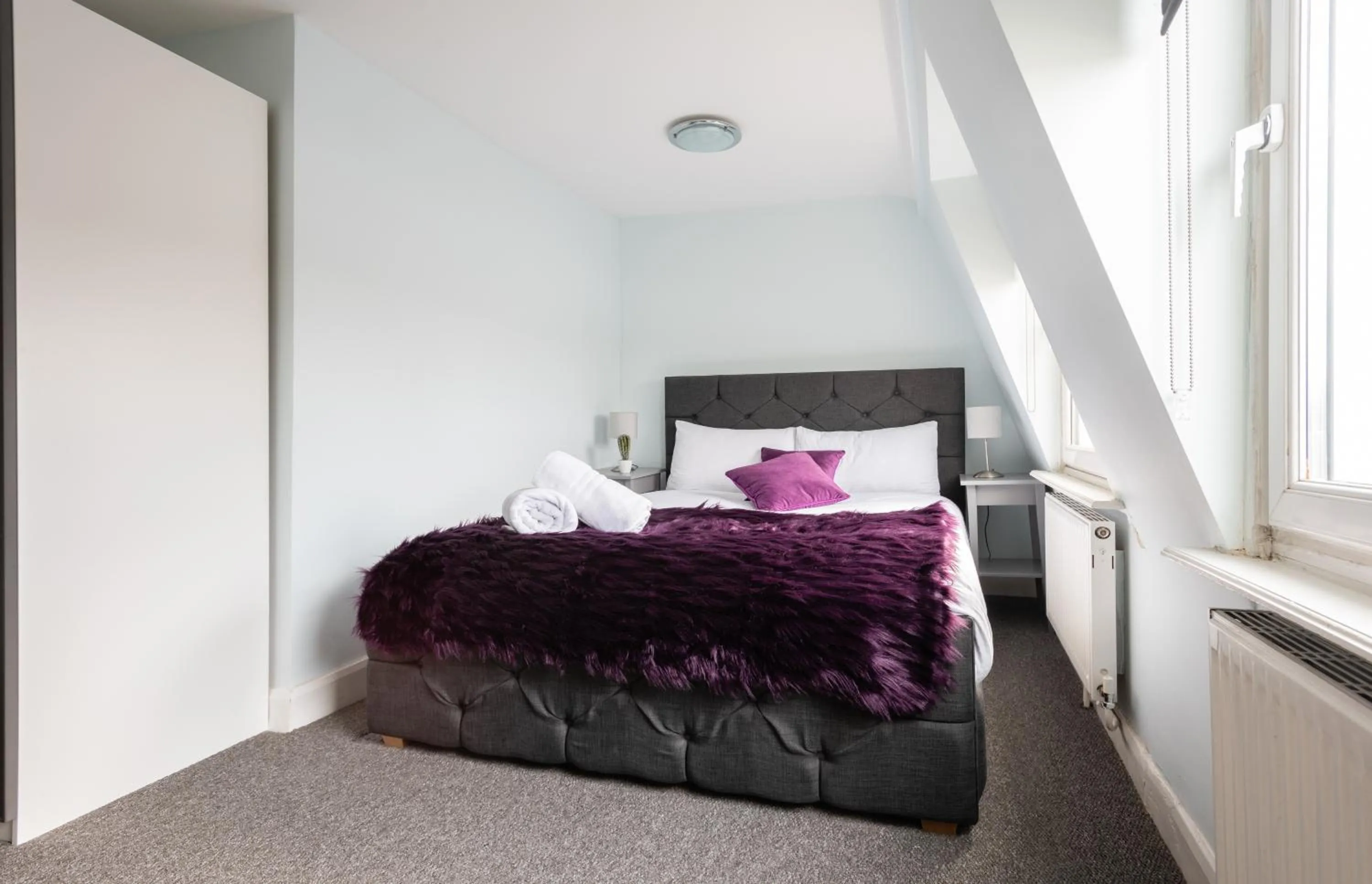 Bed in The Love Walk Apartments