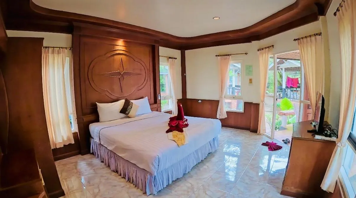 Bed in Lanta Palm Beach Resort , Beach Bungalow - Koh Lanta